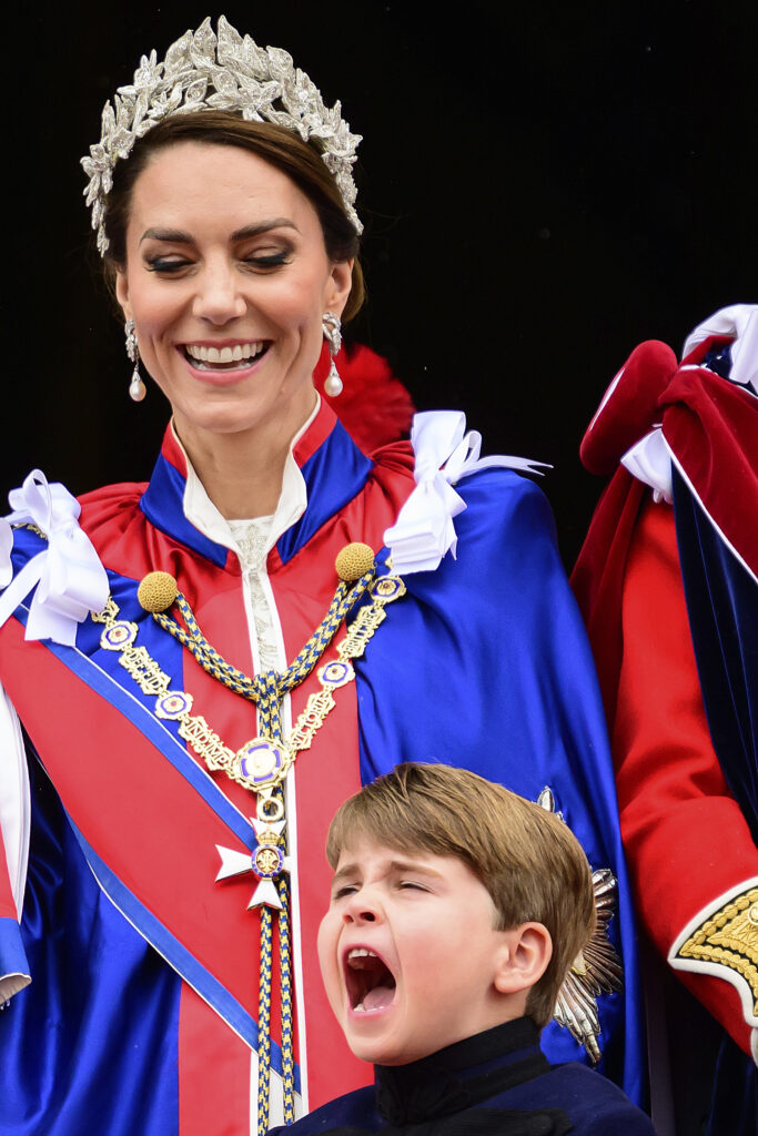 Kate, Princess of Wales, left, stands on the balcony of Buckingham Palace next to Prince Louis, down, during the coronation of Britain's King Charles III, in London, Saturday, May 6, 2023. (Leon Neal/Pool Photo via AP)