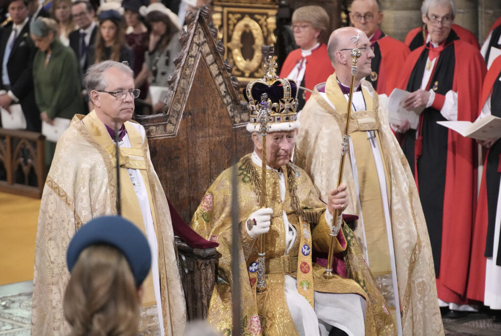 King Charles III sits as he was crowned with St Edward's Crown by The Archbishop of Canterbury the Most Reverend Justin Welby during the coronation ceremony at Westminster Abbey, London, Saturday, May 6, 2023. (Jonathan Brady/Pool Photo via AP)