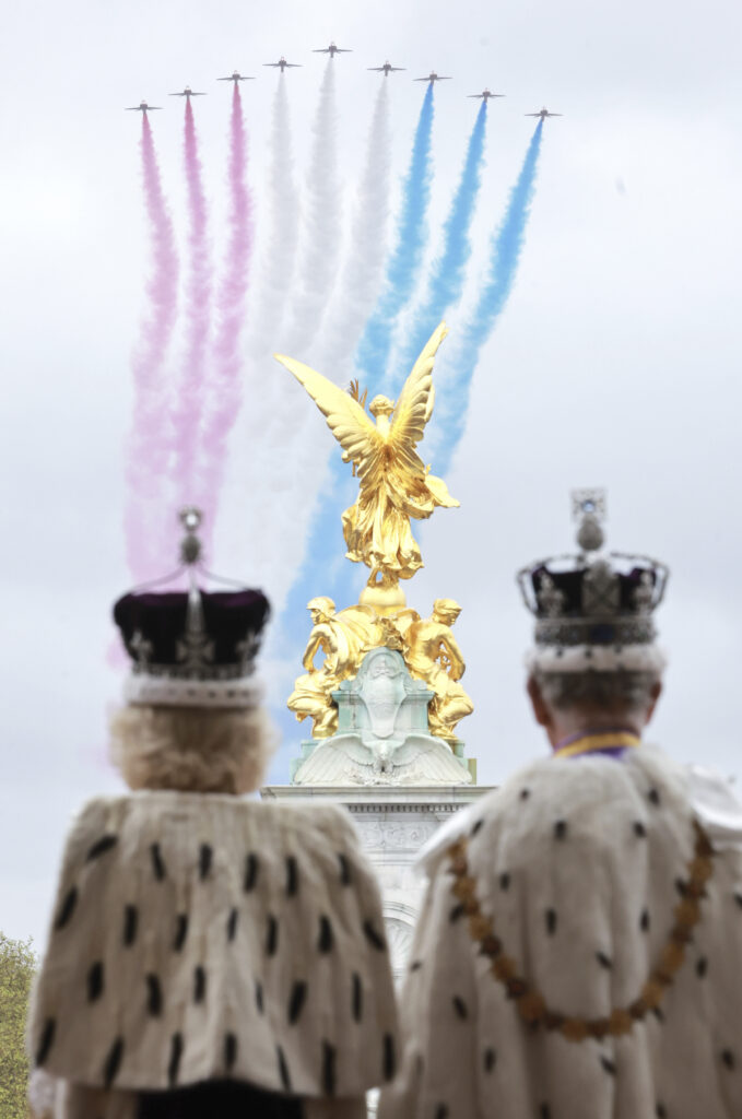 Britain's King Charles III and Queen Camilla watch the Red Arrows from the balcony of Buckingham Palace after their coronation, in London, Saturday, May 6, 2023. (Chris Jackson/Getty via AP)