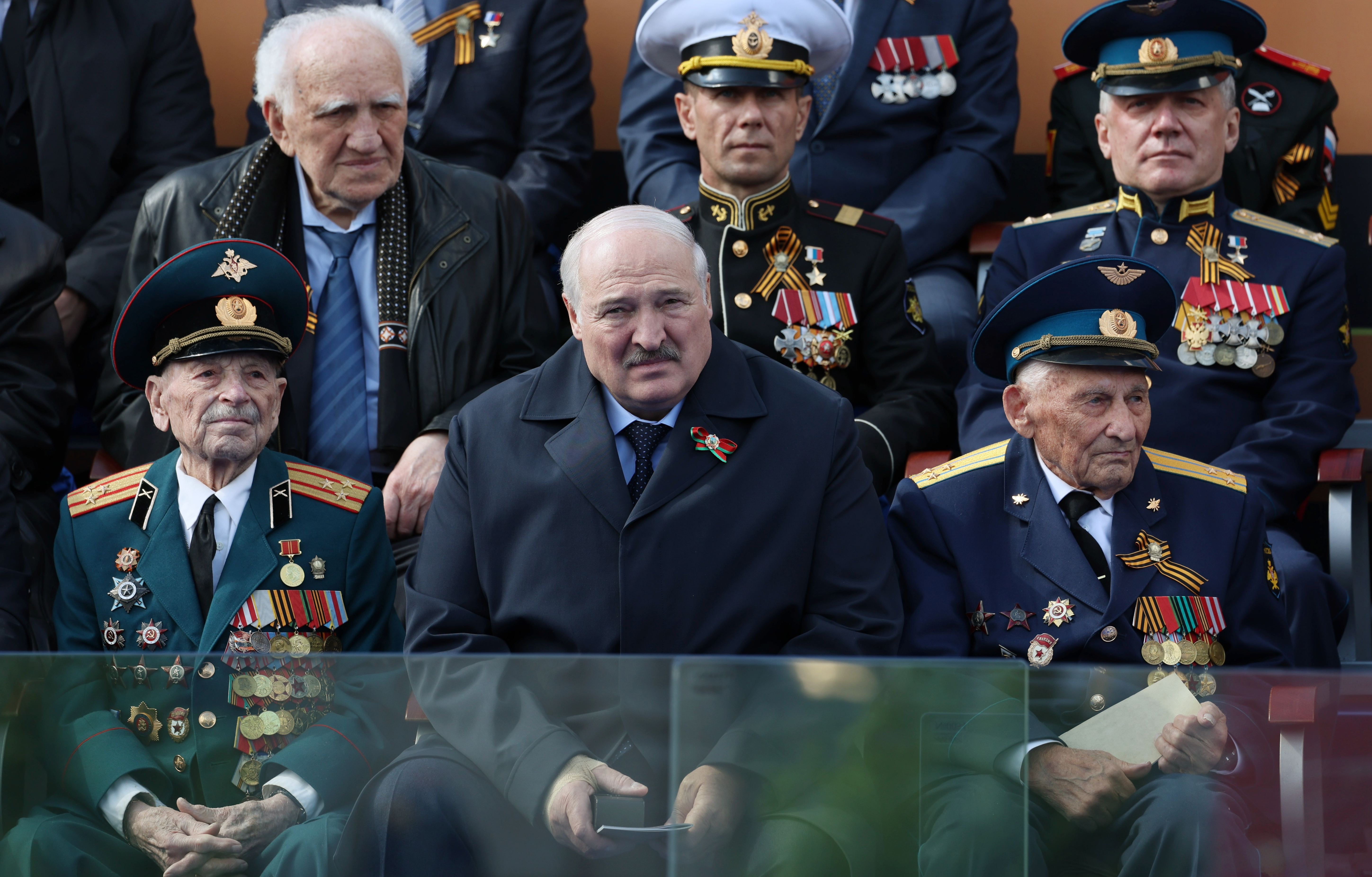 Belarusian President Alexander Lukashenko, centre, watches the Victory Day military parade marking the 78th anniversary of the end of World War II in Red square in Moscow, Russia, Monday, May 9, 2022. (Gavriil Grigorov, Sputnik, Kremlin Pool Photo via AP)