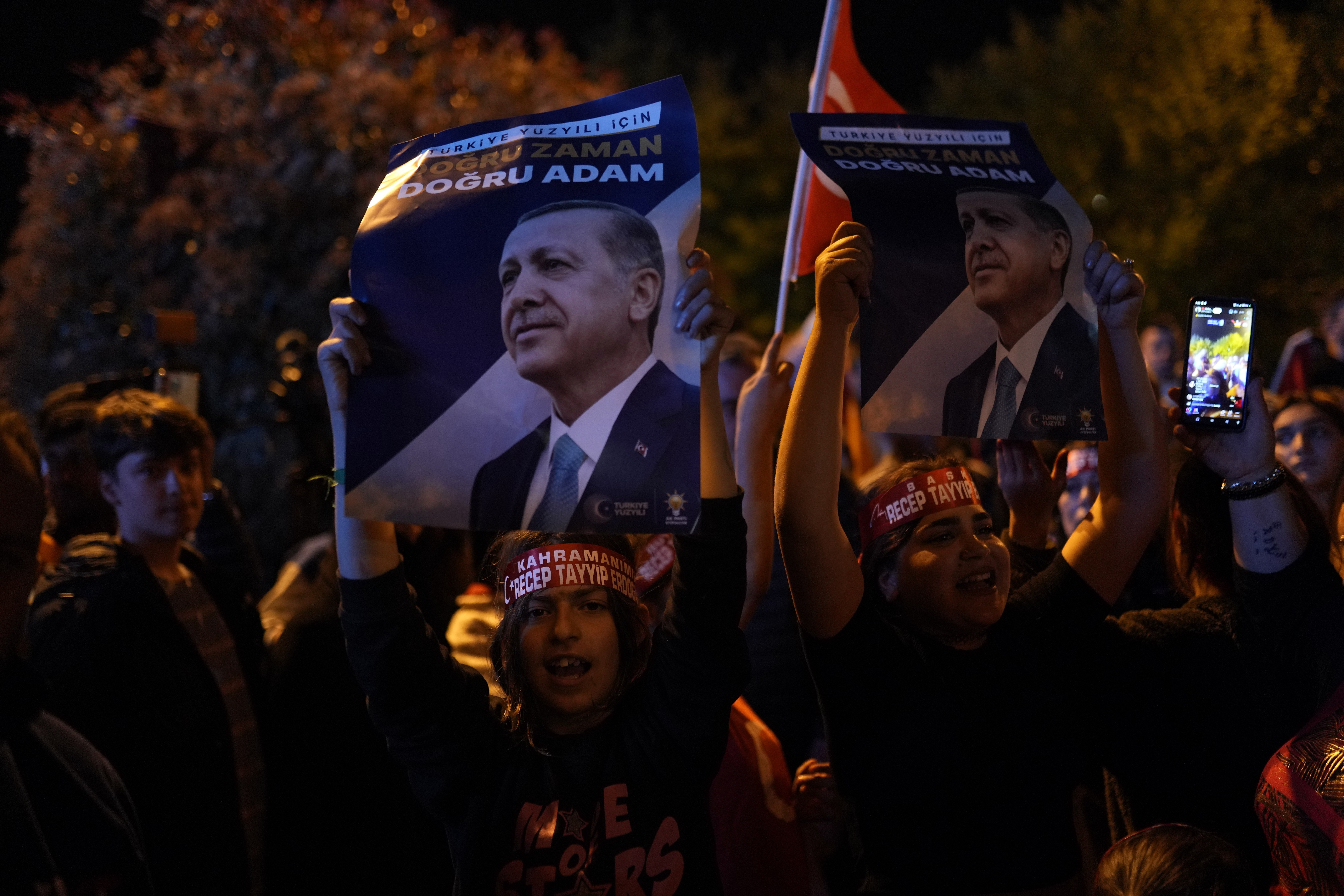 Supporters of President Recep Tayyip Erdogan shout slogans outside the headquarters of AK Party in Istanbul, Turkey, Sunday, May 14, 2023. More than 64 million people, including 3.4 million overseas voters, were eligible to vote. (AP Photo/Francisco Seco)