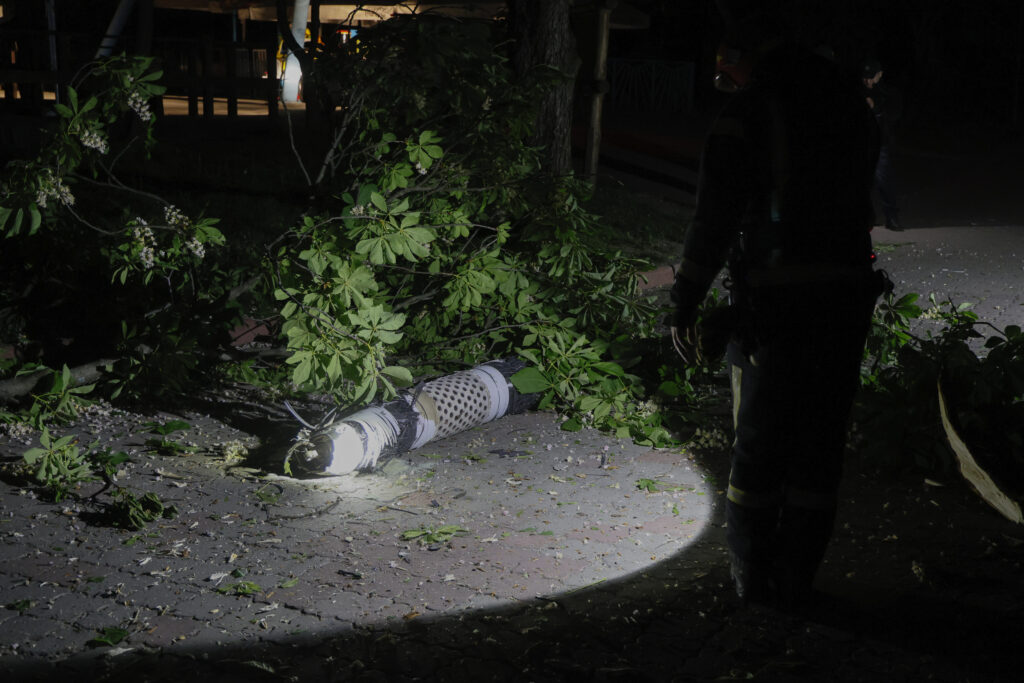 Police officers investigate fragments of a Russian rocket that fell down in a city zoo after it was shot down by air defense system during the night Russian rocket attack in Kyiv, Ukraine, early Tuesday, May 16, 2023. (AP Photo/Alex Babenko)