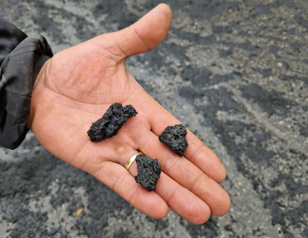 epa10643702 A person shows copious volcanic ash due to the eruptive activity of Etna Volcano on the square of the Rifugio Sapienza, Nicolosi, Sicily island, Italy, 21 May 2023.  EPA-EFE/ORIETTA SCARDINO