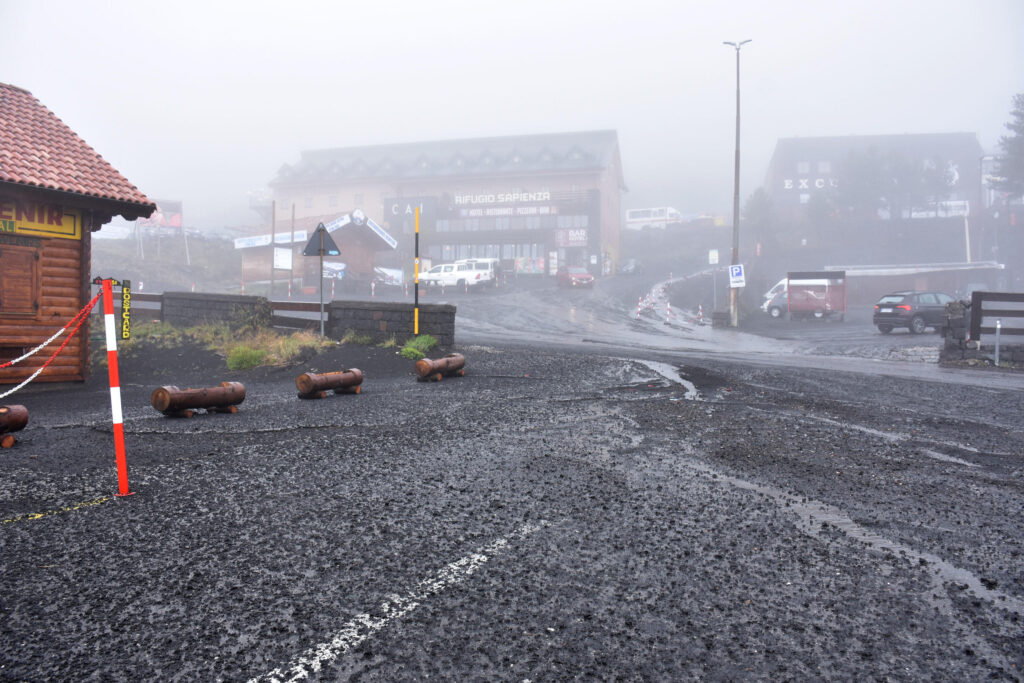 epa10643697 A general view on the fallout of copious volcanic ash due to the eruptive activity of Etna Volcano on the square of the Rifugio Sapienza, Nicolosi, Sicily island, Italy, 21 May 2023.  EPA-EFE/ORIETTA SCARDINO