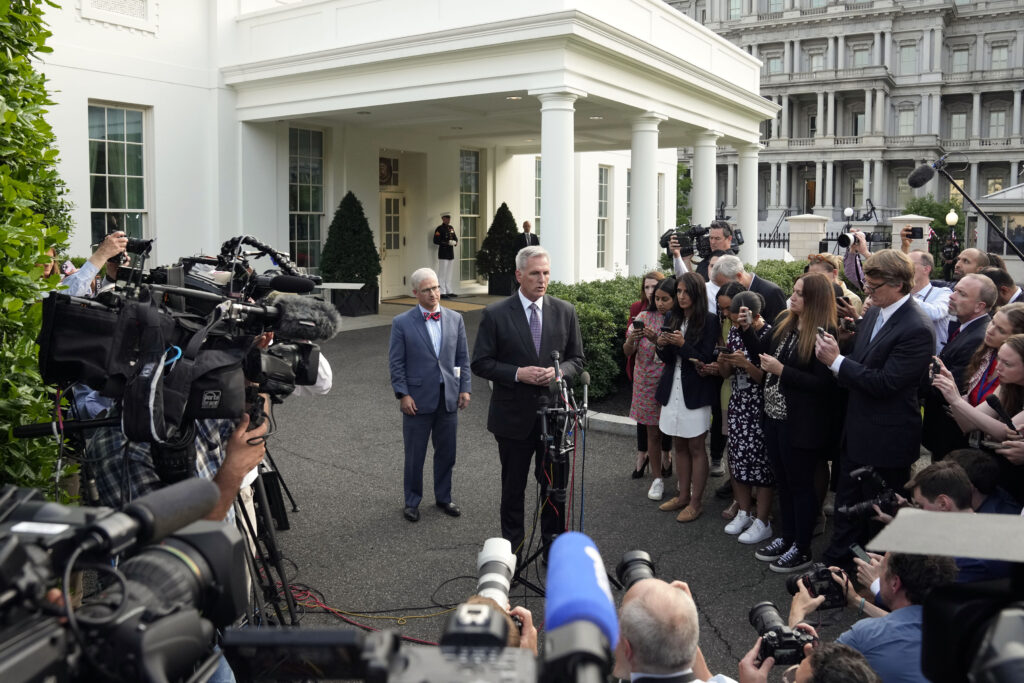 Speaker of the House Kevin McCarthy of Calif., talks to reporters as Rep. Patrick McHenry, R-N.C., listens after meeting with President Joe Biden at the White House, Monday, May 22, 2023, in Washington. (AP Photo/Alex Brandon)