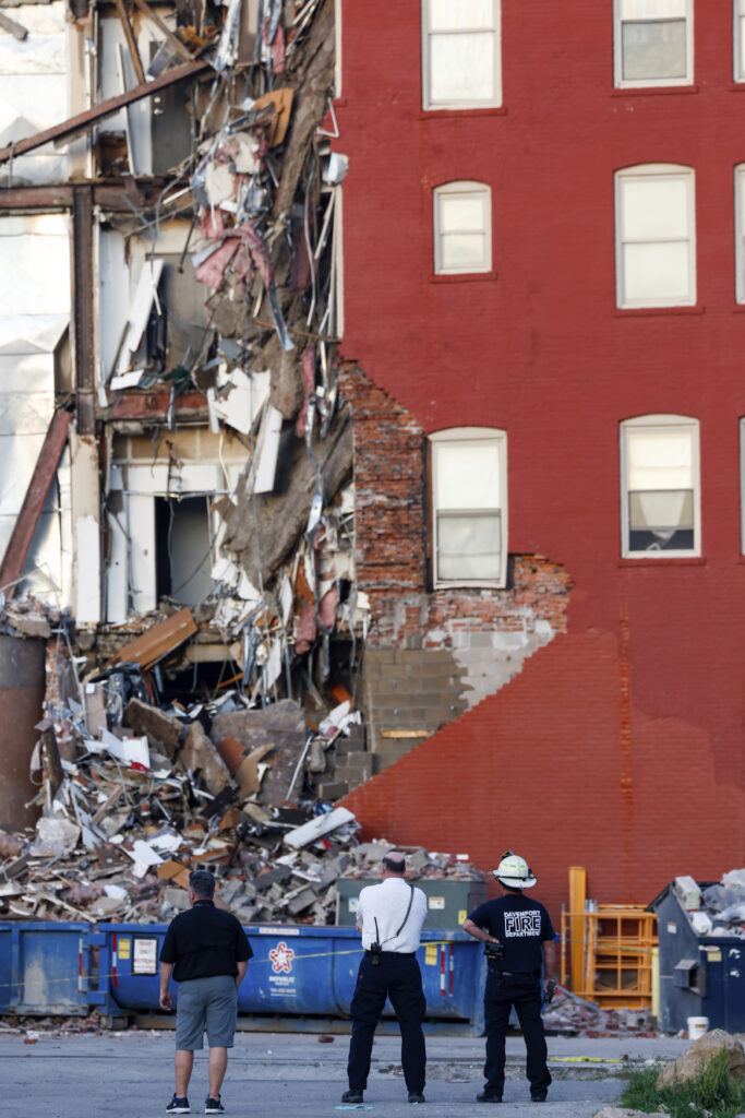 Emergency crews work the scene of a partial building collapse on the 300 block of Main Street, Sunday, May 28, 2023, in Davenport, Iowa. (Nikos Frazier/Quad City Times via AP)