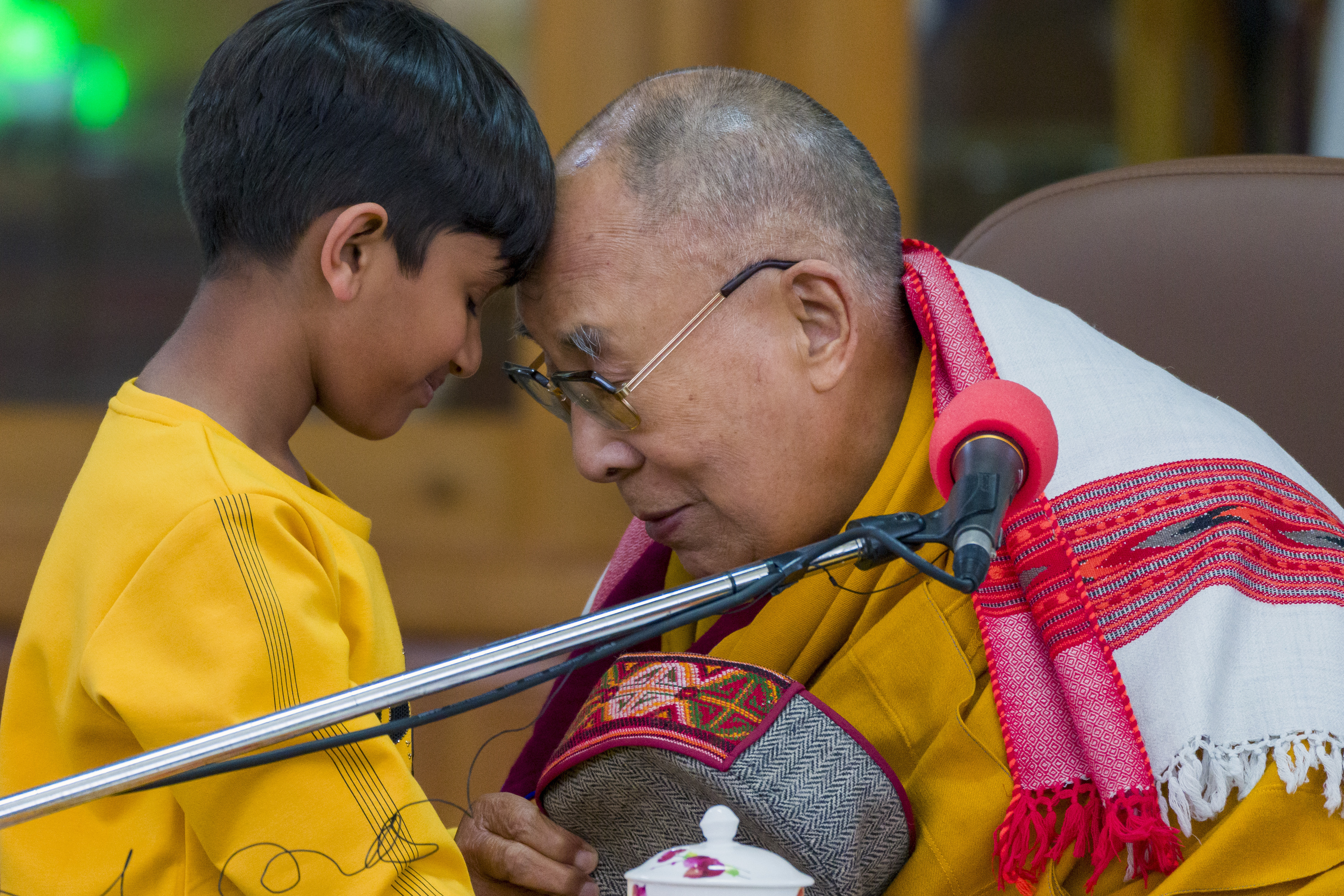 Tibetan spiritual leader the Dalai Lama touches foreheads with a young boy before addressing a group of students at the Tsuglakhang temple in Dharamshala, India, Tuesday, Feb. 28, 2023. (AP Photo/Ashwini Bhatia)