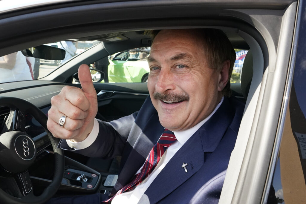 MyPillow CEO Mike Lindell gives a thumbs up as he passes by a rally for supporters of former President Donald Trump, Tuesday, April 4, 2023, in West Palm Beach, Fla. (AP Photo/Wilfredo Lee)