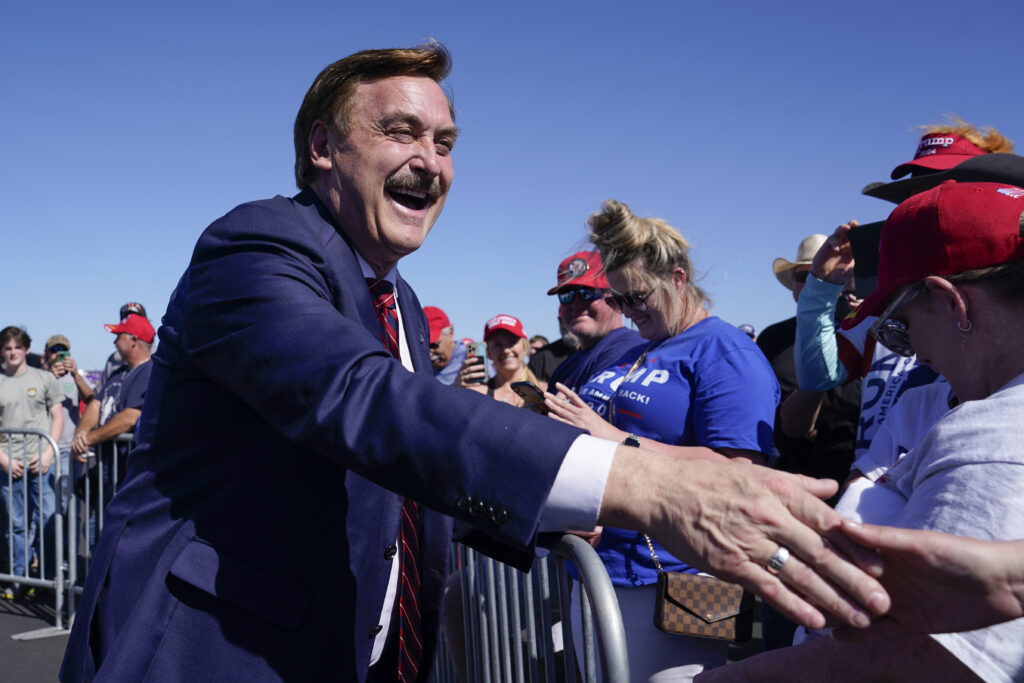 My Pillow CEO Mike Lindell greets people before former President Donald Trump speaks at a campaign rally at Waco Regional Airport Saturday, March 25, 2023, in Waco, Texas. (AP Photo/Nathan Howard)