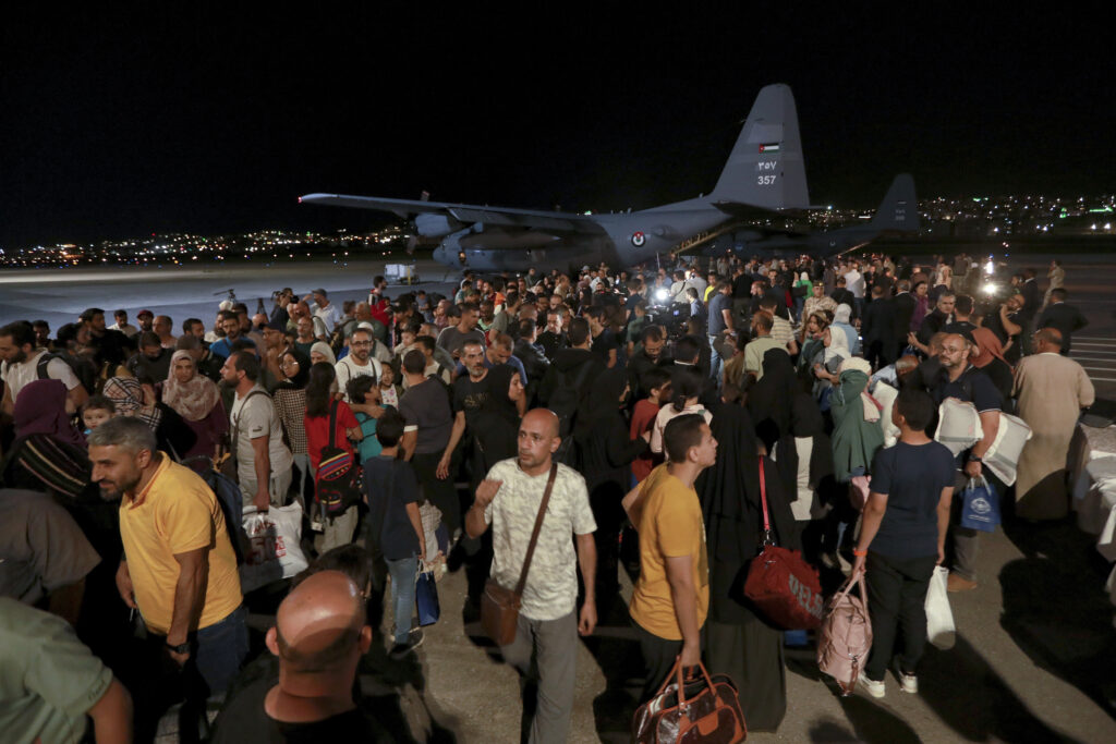 Jordanians evacuated form Sudan arrive to a military airport in Amman, Jordan, Monday, April 24, 2023. (AP Photo/Raad Adayleh)