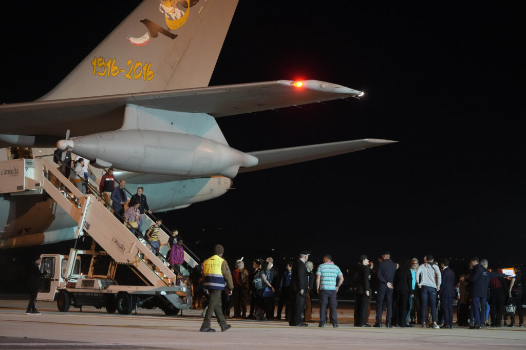 People disembark from an Air Force plane carrying Italian citizens evacuated from Sudan landed at the Ciampino Military airport in Rome, Monday, April 24, 2023. (AP Photo/Gregorio Borgia)