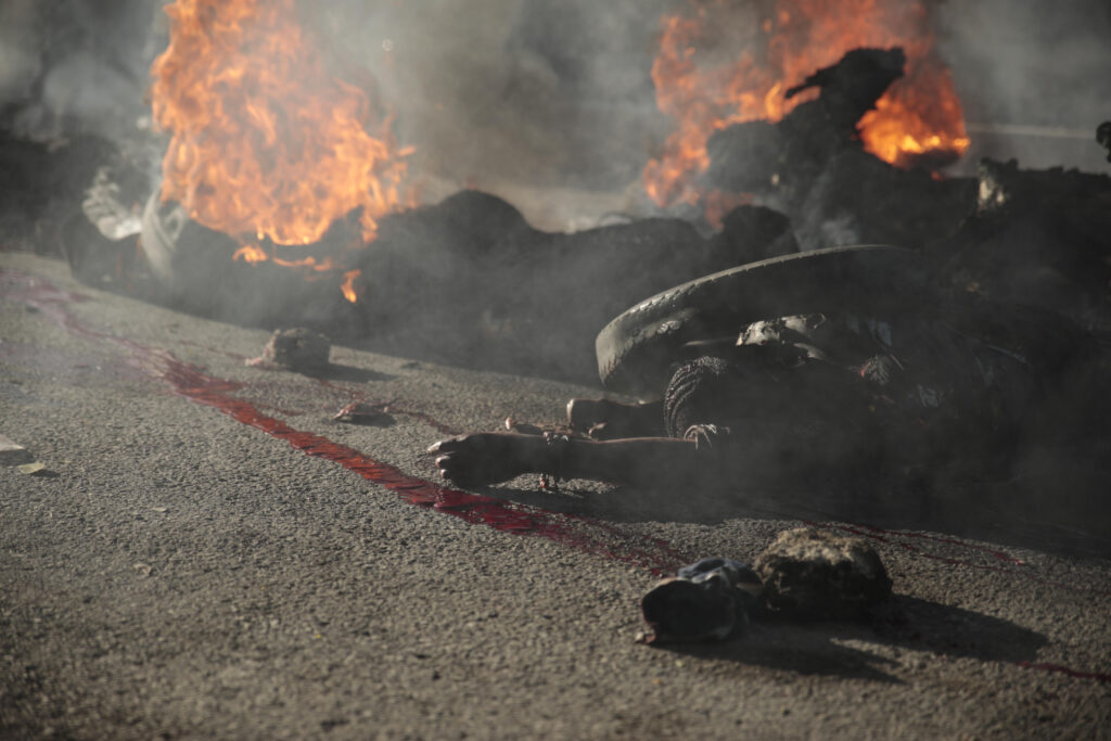 EDS NOTE: GRAPHIC CONTENT - The bodies of alleged gang members burn on the street after they were set on fire by a mob in the Canape Vert area of Port-au-Prince, Haiti, Monday, April 24, 2023. (AP Photo/Odelyn Joseph)
