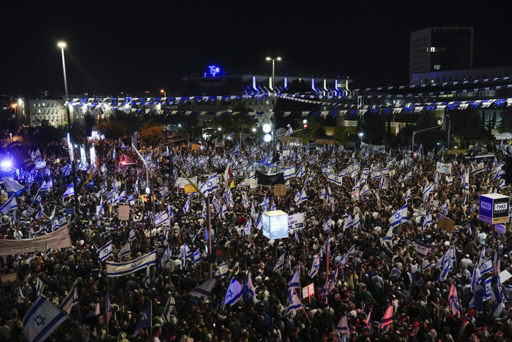 Right-wing Israelis attend a rally in support of plans by Prime Minister Benjamin Netanyahu's government to overhaul the judicial system, outside the Knesset, Israel's parliament in Jerusalem, Thursday, April 27, 2023. (AP Photo/Ohad Zwigenberg)