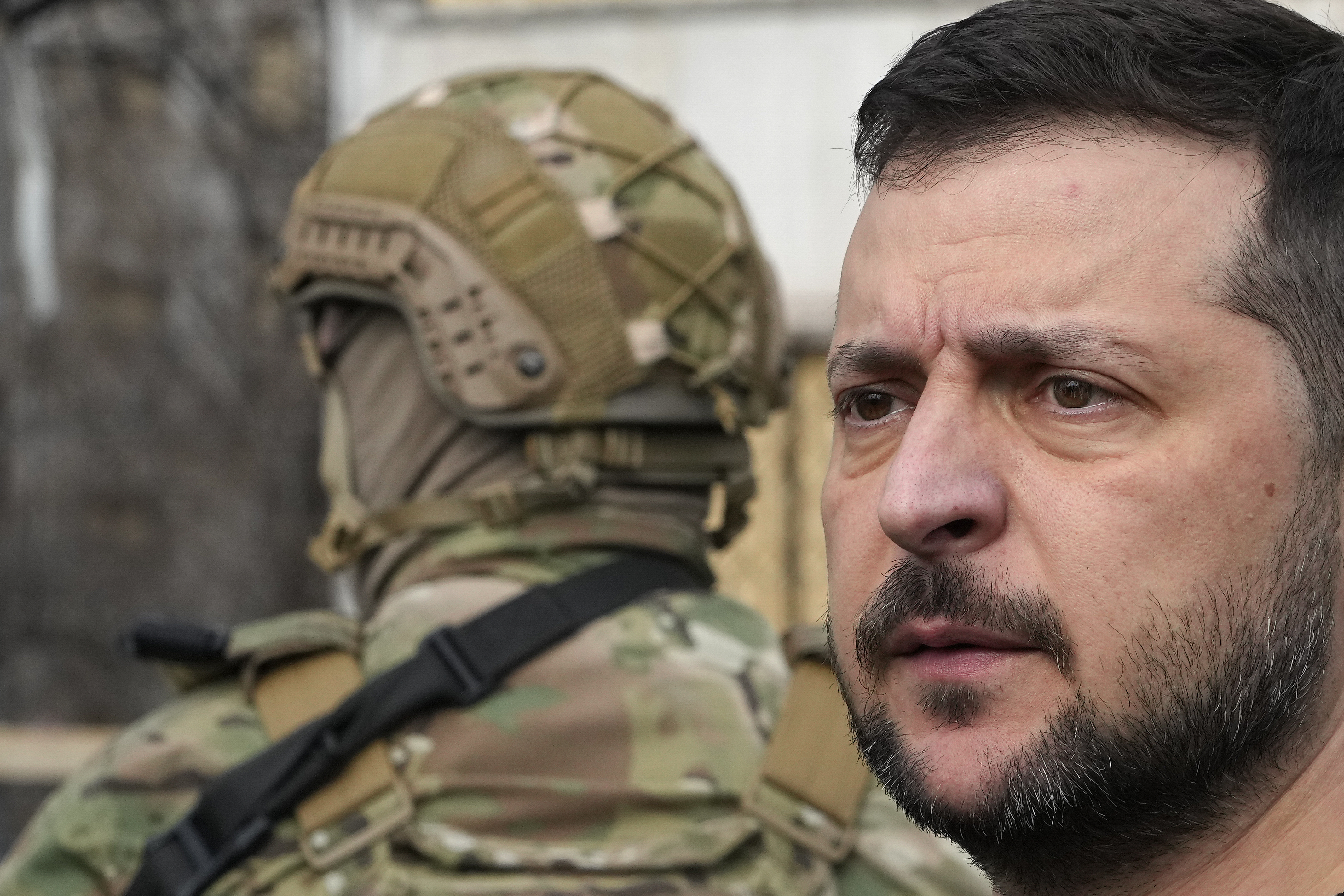Ukraine's President Volodymyr Zelenskyy visits a missile-damaged area Zaporizhzhia, Ukraine, Monday March 27, 2023. (AP Photo/Efrem Lukatsky)
