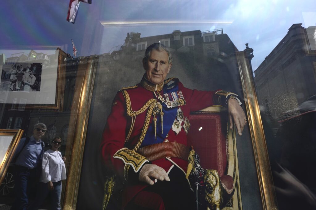 A portrait of Britain's King Charles III is displayed in a store ahead of his coronation, in Central London, Saturday, April 29, 2023. (AP Photo/Kin Cheung)