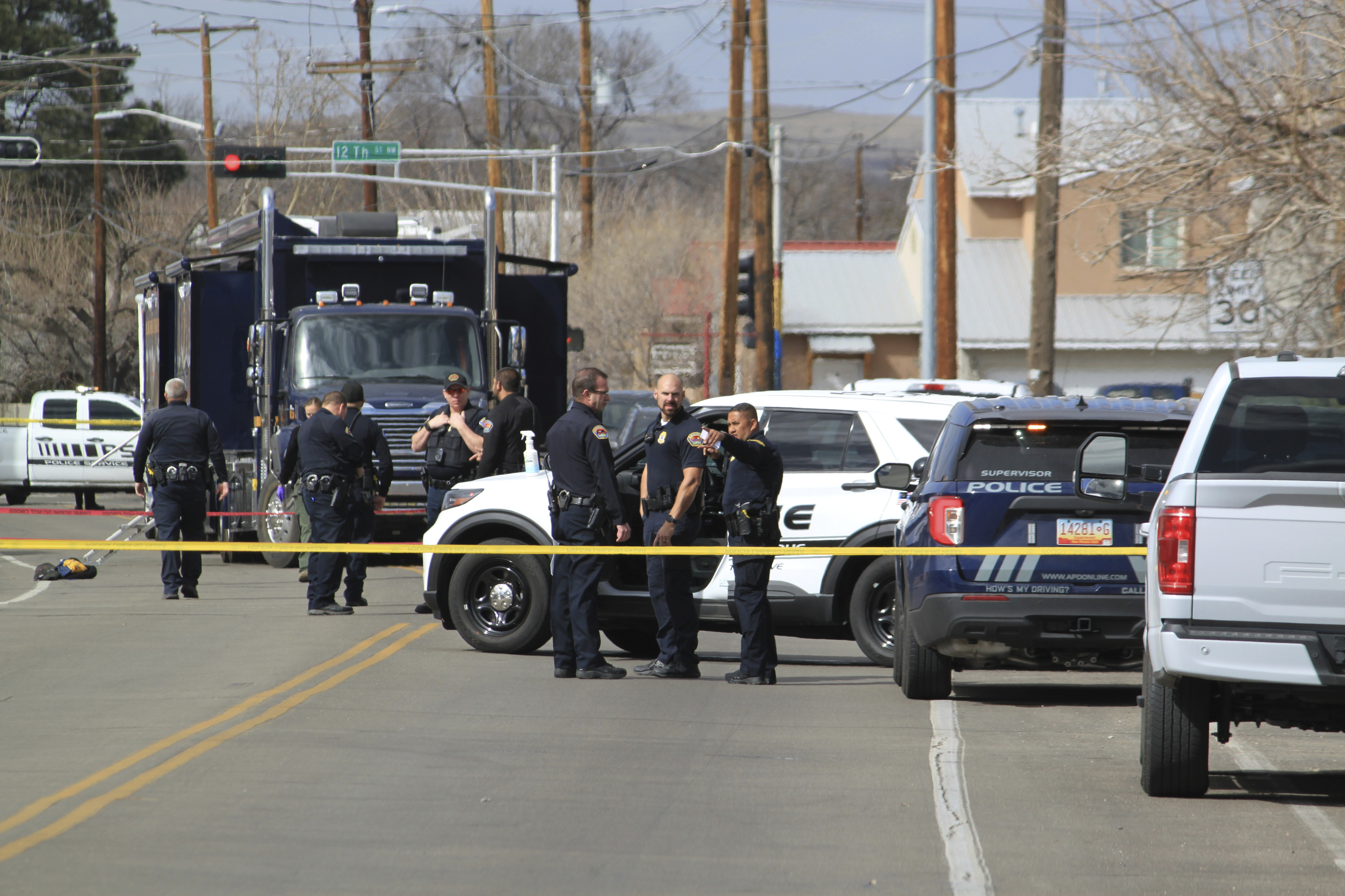 Police are seen outside a home of a fatal shooting in Albuquerque, N.M., on Thursday, Feb. 23, 2023. Authorities say multiple people were wounded. (AP Photo/Susan Montoya Bryan)