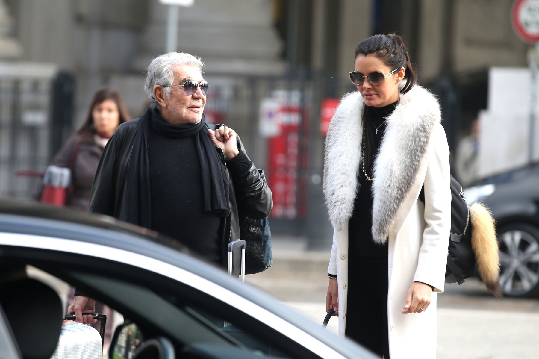 *EXCLUSIVE* The Italian fashion designer Roberto Cavalli has a wardrobe malfunction with open zip while walking with his partner Lina Nilson at a Milan train station.