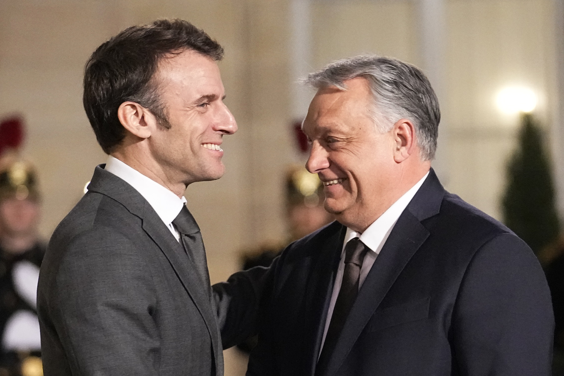 French President Emmanuel Macron, left, welcomes Hungarian Prime Minister Viktor Orban as they meet at the Elysee Palace in Paris, France, Monday, March 13, 2023. (AP Photo/Michel Euler)