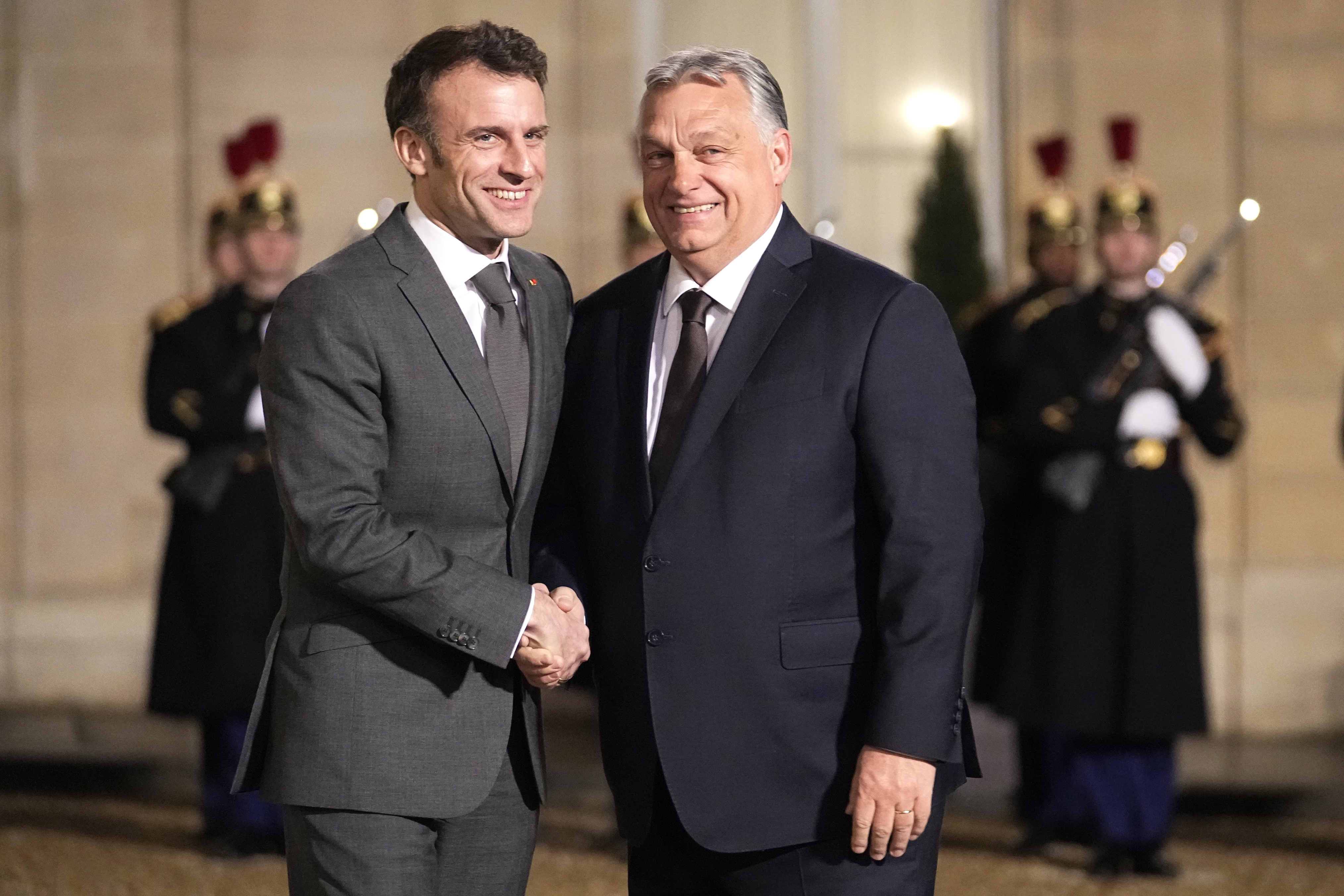 French President Emmanuel Macron, left, welcomes Hungarian Prime Minister Viktor Orban as they meet at the Elysee Palace in Paris, France, Monday, March 13, 2023. (AP Photo/Michel Euler)