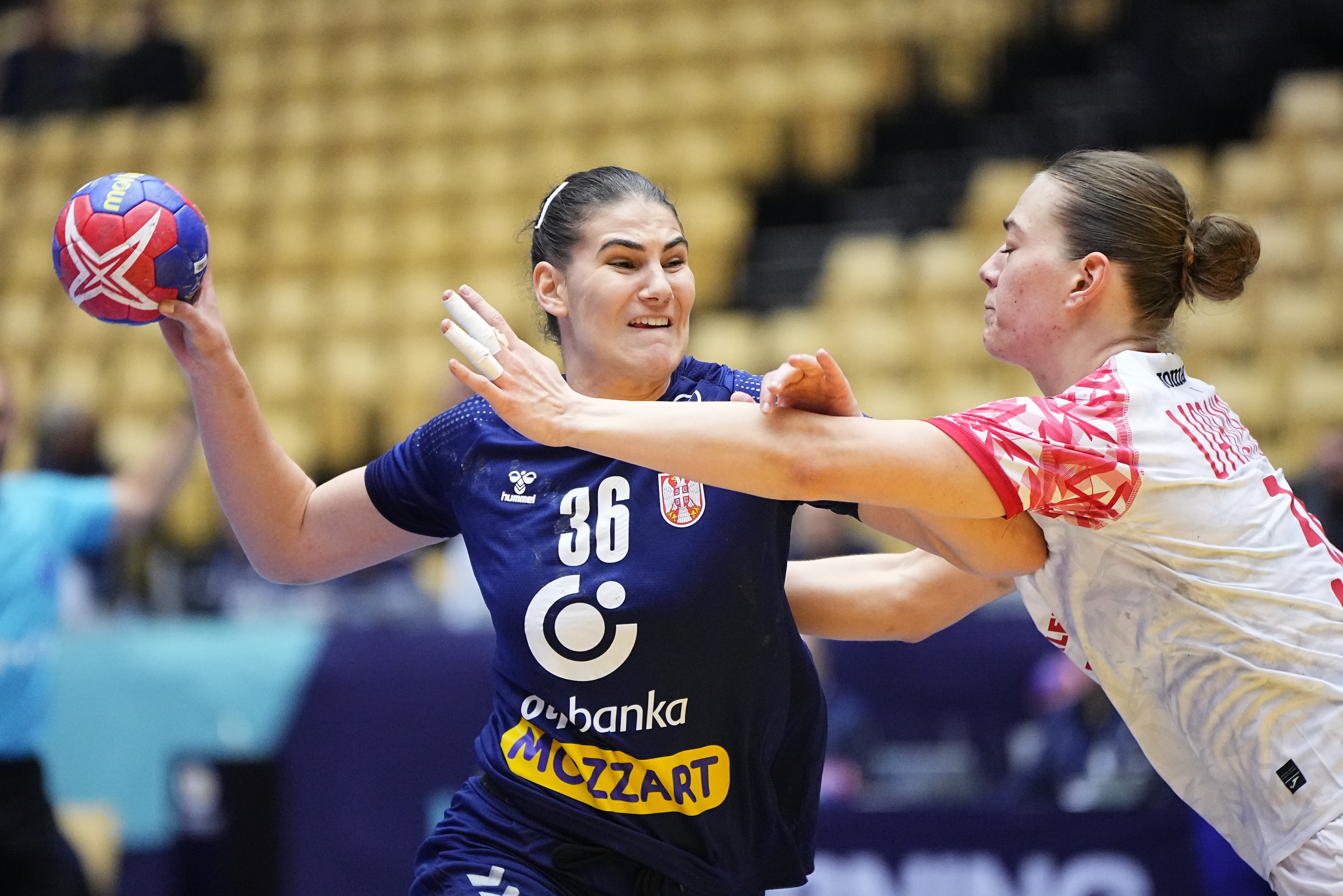 Serbia's Emilja Lazic, left, in action during a Group 3, main round IHF World Women's Handball Championship match between Serbia and Poland at Arena Nord, in Frederikshavn, Denmark, Thursday, Dec. 7, 2023. (Bo Amstrup/Ritzau Scanpix via AP)
