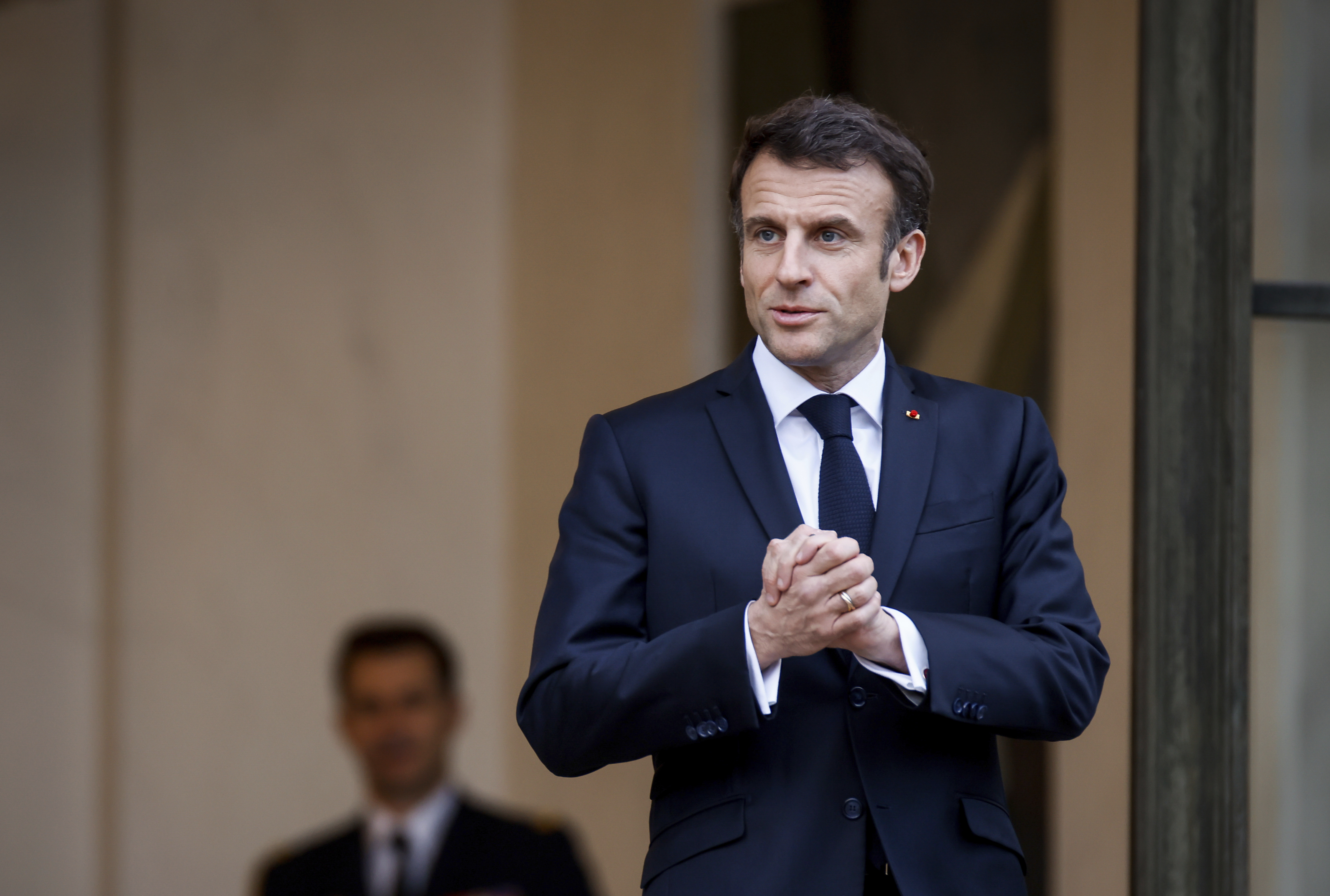 French President Emmanuel Macron talks to the media as he awaits President of Costa Rica Rodrigo Chaves Robles for a meeting at the Elysee Palace in Paris, Friday, March 24, 2023. (AP Photo/Thomas Padilla)