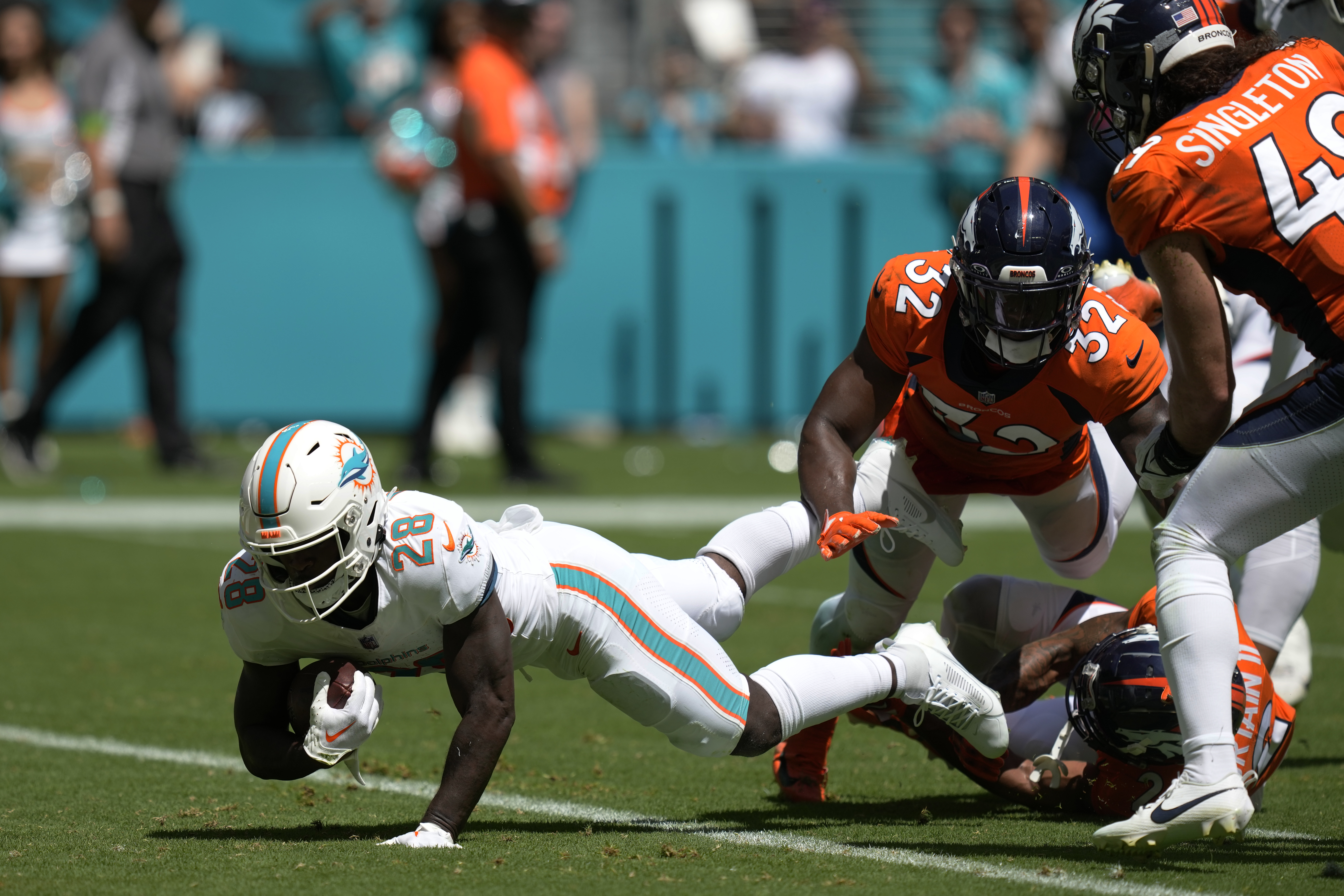 Miami Dolphins running back De'Von Achane (28) scores a touchdown during the first half of an NFL football game against the Denver Broncos, Sunday, Sept. 24, 2023, in Miami Gardens, Fla. (AP Photo/Rebecca Blackwell)