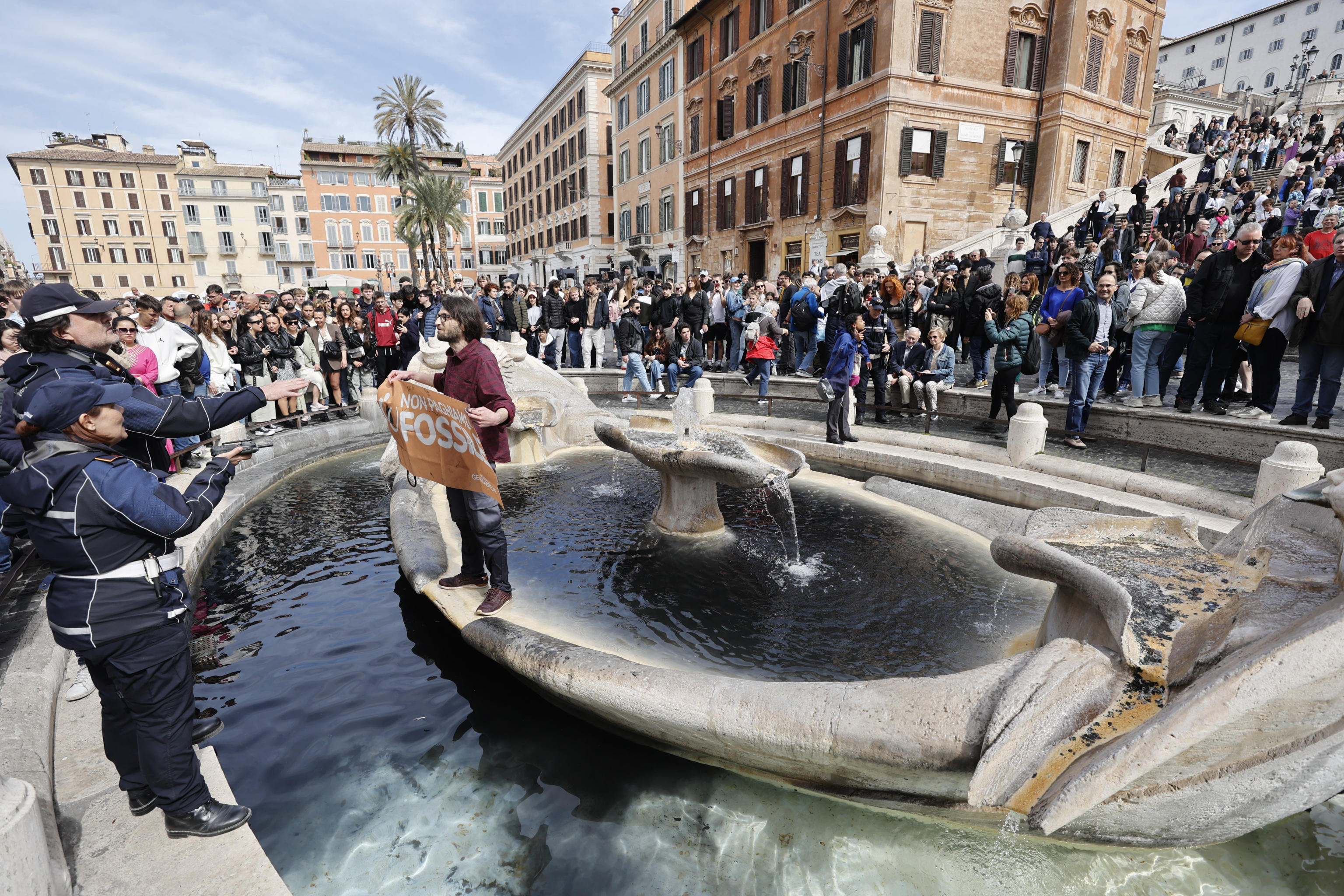 Environmental activists pour black liquid into Rome's iconic Barcaccia fountain