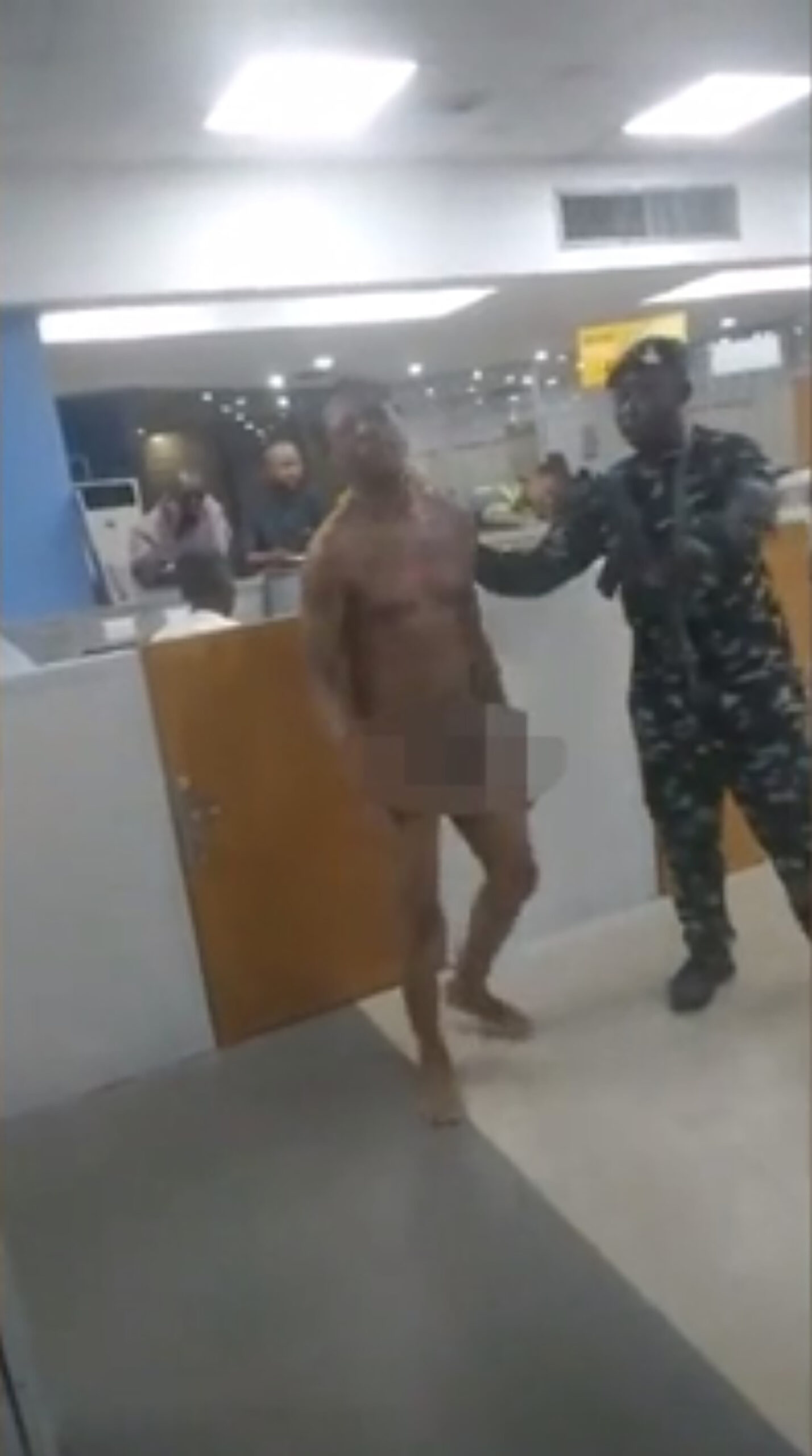 Desperate bank customers strip naked and fight in mass brawls to get to ATMs in chaotic scenes in Nigeria after Government replaced bank notes...but printed too few