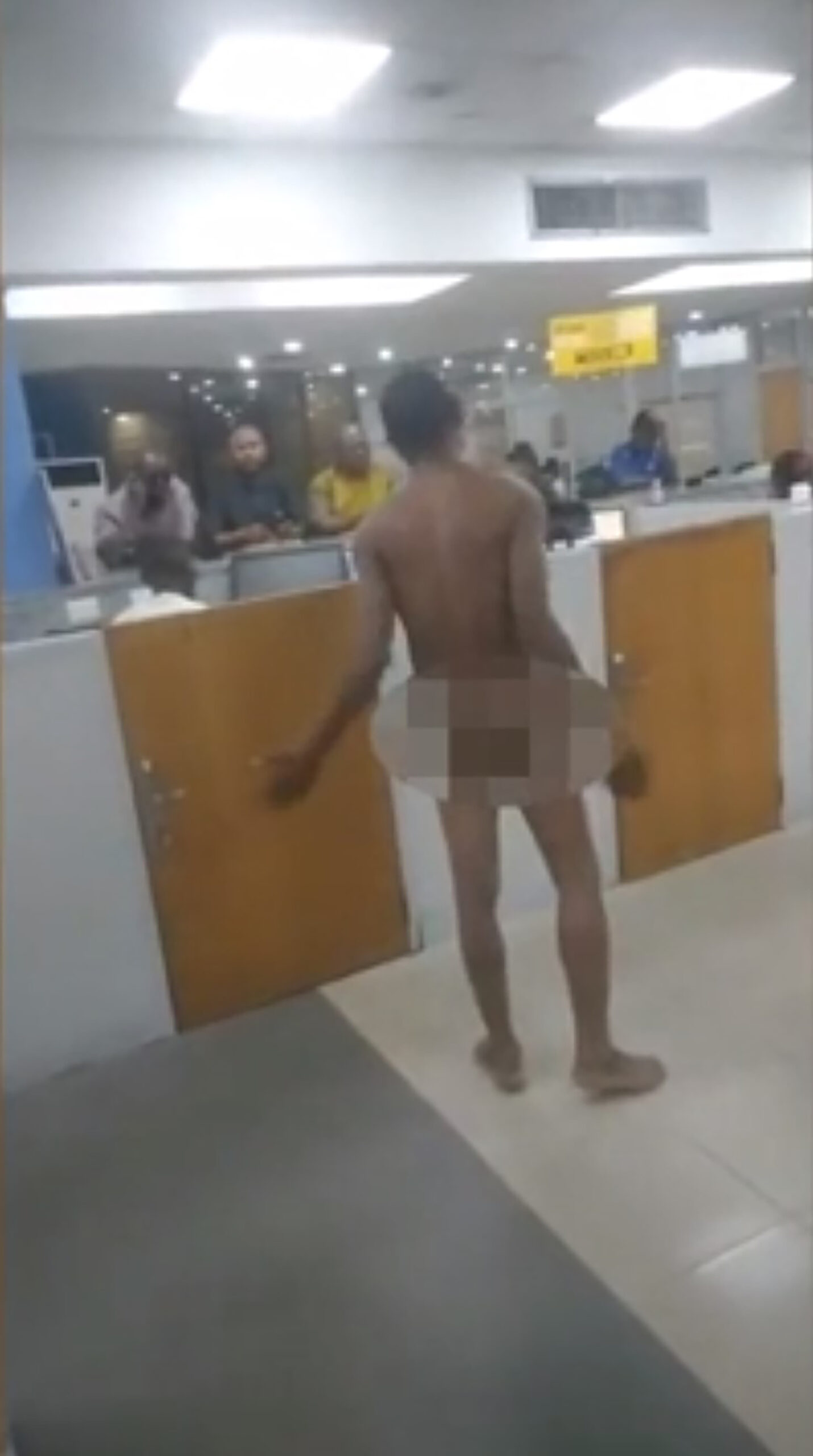 Desperate bank customers strip naked and fight in mass brawls to get to ATMs in chaotic scenes in Nigeria after Government replaced bank notes...but printed too few