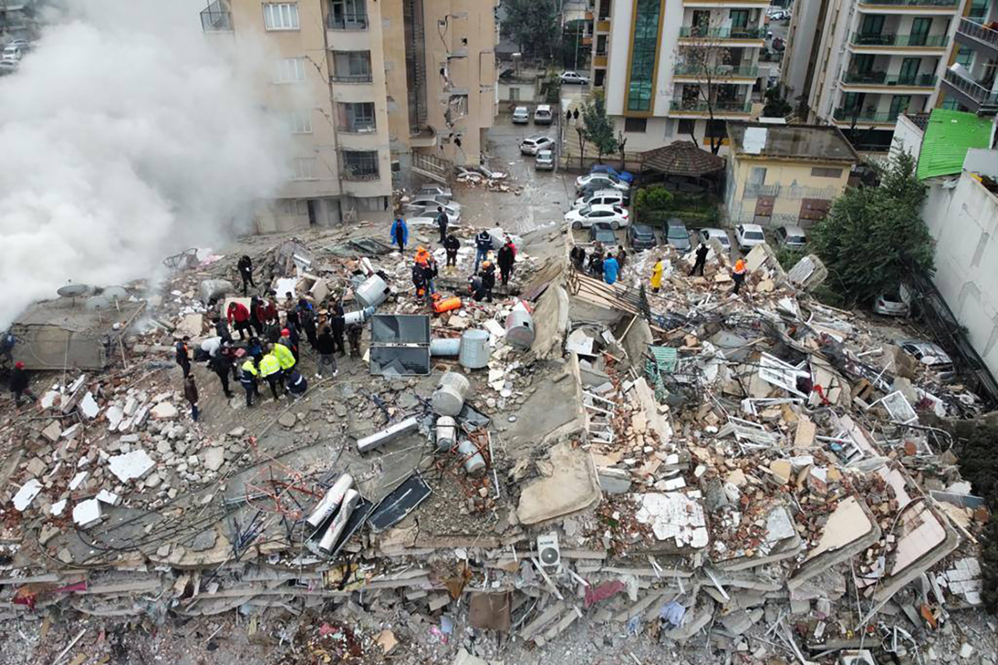 Emergency teams search for people in a destroyed building in Kahramanmaras, Turkey, Monday, Feb. 6, 2023. A powerful quake has knocked down multiple buildings in southeast Turkey and Syria and many casualties are feared. (DIA Images via AP)