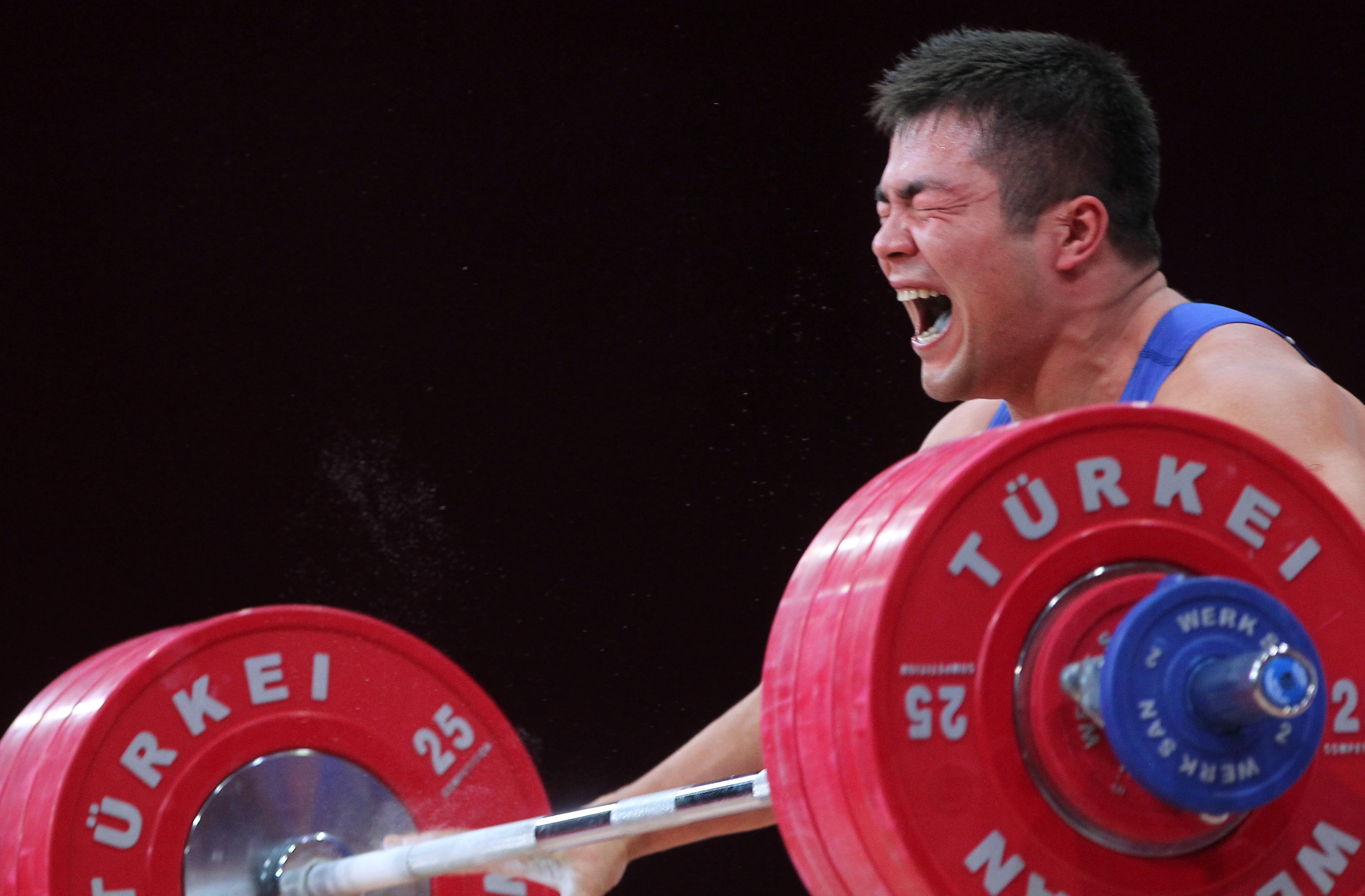 epa03925669 Vladimir Sedov of Kazakhstan in action during the snatch discipline of the men's 94 kg category at the World Weightlifting Championships in Wroclaw, Poland, 26 October 2013.  EPA/RADEK PETRUSZKA  POLAND OUT