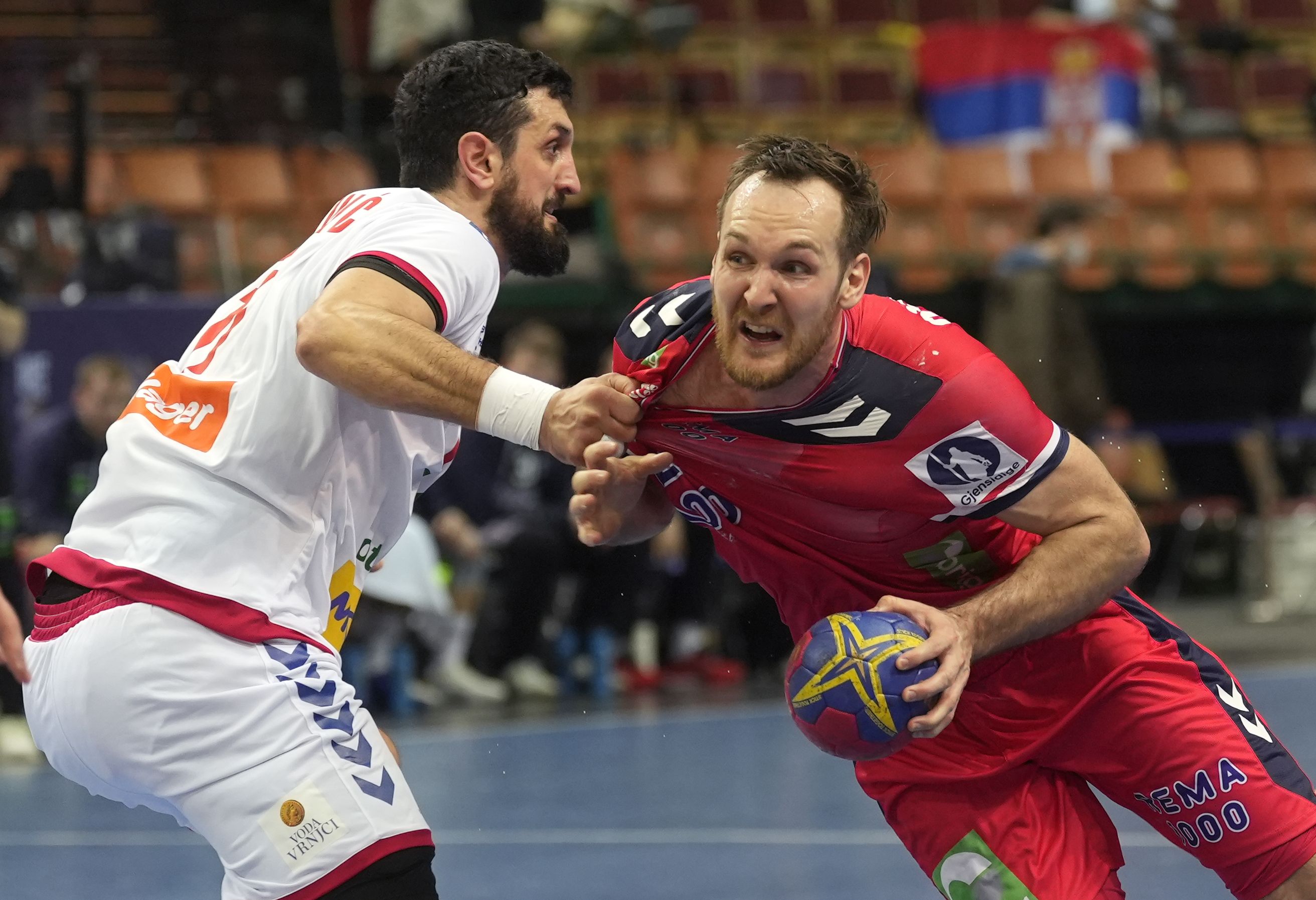 Serbia's Ilija Abutovic, left, in action against Norway's Christian O'Sullivan during the Main Round Group III, Handball World Championship match between Norway and Serbia in Katowice, Poland, Thursday, Jan. 19, 2023. (AP Photo/Piotr Hawalej)