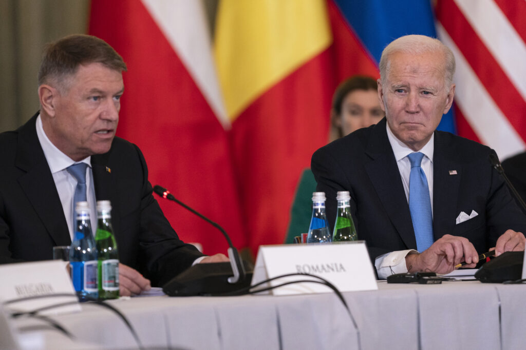 President Joe Biden listens as Romanian President Klaus Iohannis speaks during a meeting with the leaders of the Bucharest Nine, a group of nine countries that make up the eastern flank of NATO, Wednesday, Feb. 22, 2023, in Warsaw. (AP Photo/ Evan Vucci)