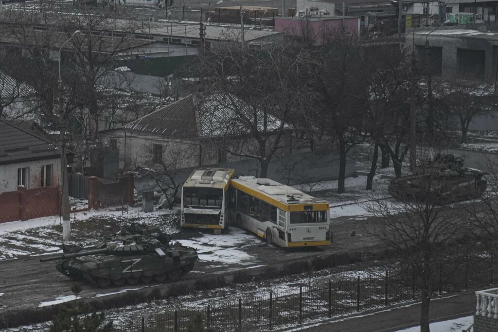 FILE - Russian's army tanks move down a street on the outskirts of Mariupol, Ukraine, Friday, March 11, 2022.  (AP Photo/Evgeniy Maloletka, File)