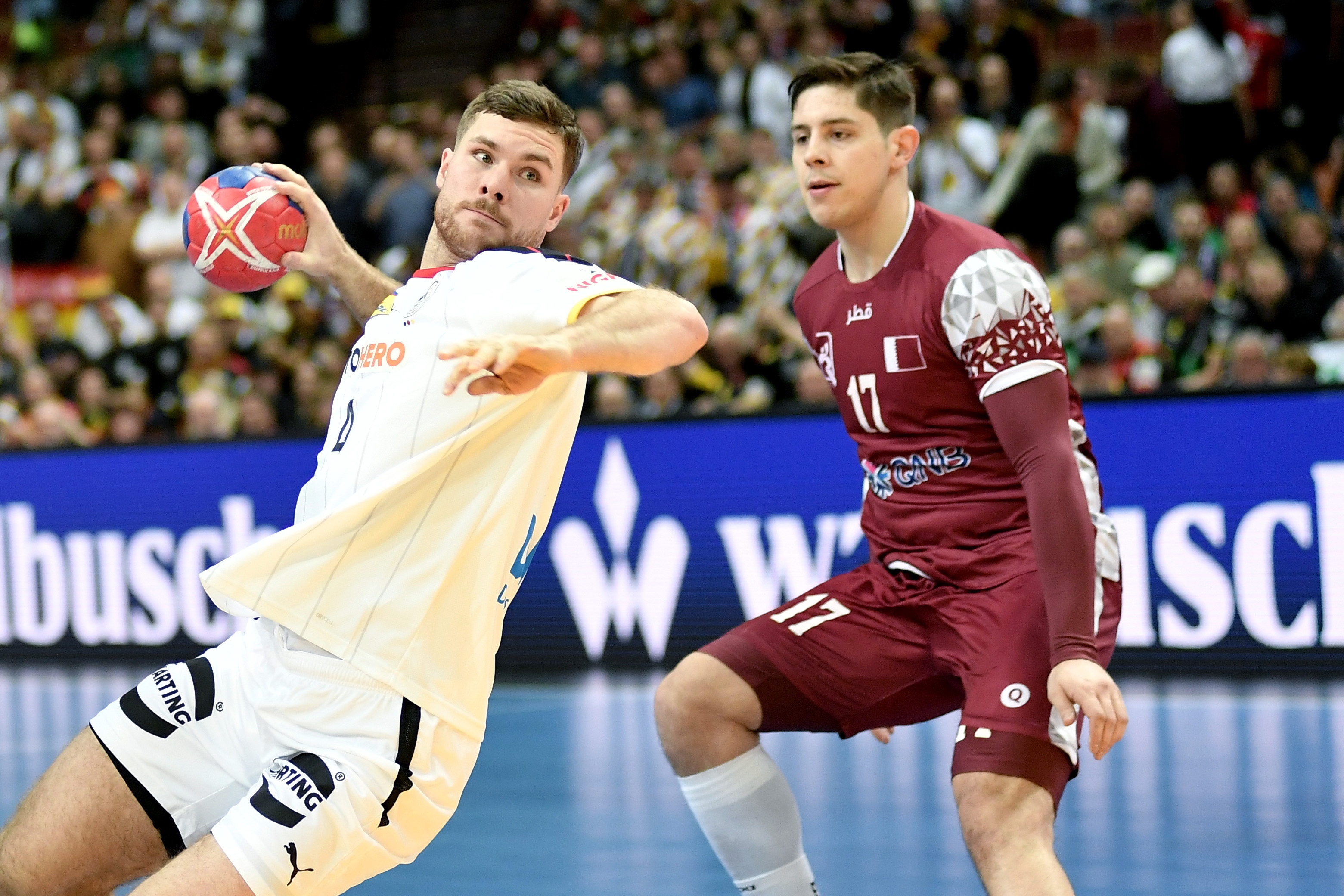 epa10403635 Johannes Golla (L) of Germany and Jovan Gacevic (R) of Qatar in action during the IHF Men's World Championship group E handball match between Germany and Qatar in Katowice, Poland, 13 January 2023.  EPA-EFE/Zbigniew Meissner POLAND OUT