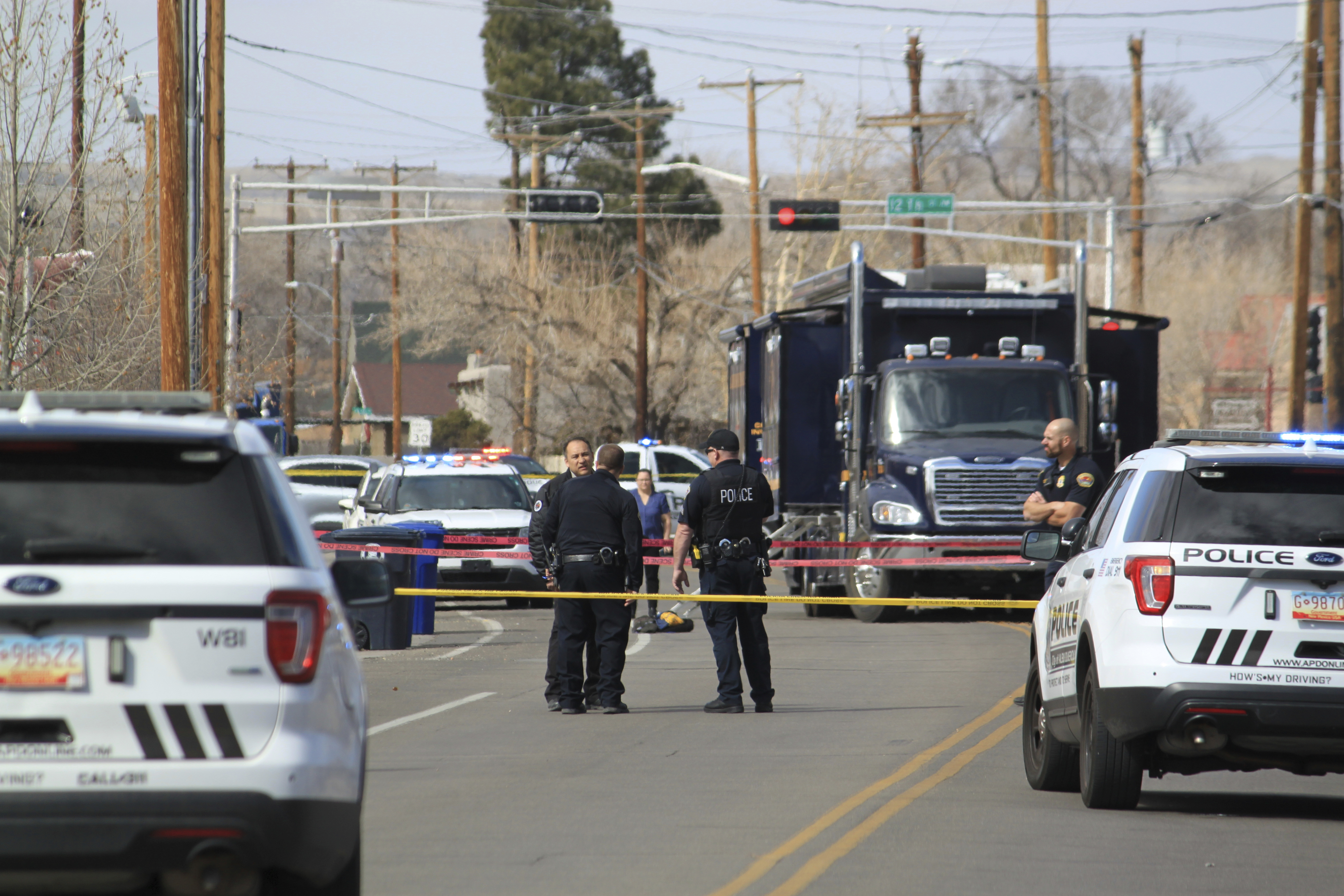 Police are seen outside a home of a fatal shooting in Albuquerque, N.M., on Thursday, Feb. 23, 2023. Authorities say multiple people were wounded. (AP Photo/Susan Montoya Bryan)