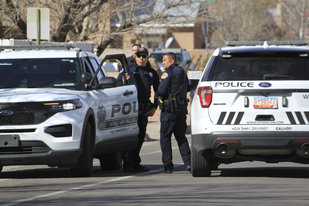 Police are seen outside a home of a fatal shooting in Albuquerque, N.M., on Thursday, Feb. 23, 2023. Authorities say multiple people were wounded. (AP Photo/Susan Montoya Bryan)