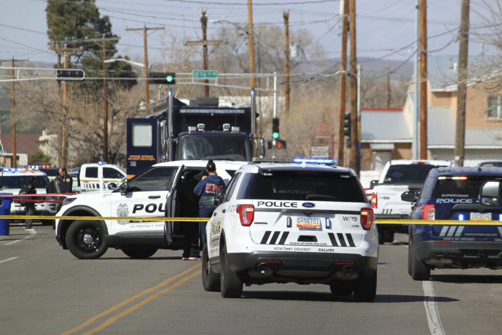 Police are seen outside a home of a fatal shooting in Albuquerque, N.M., on Thursday, Feb. 23, 2023. Authorities say multiple people were wounded. (AP Photo/Susan Montoya Bryan)