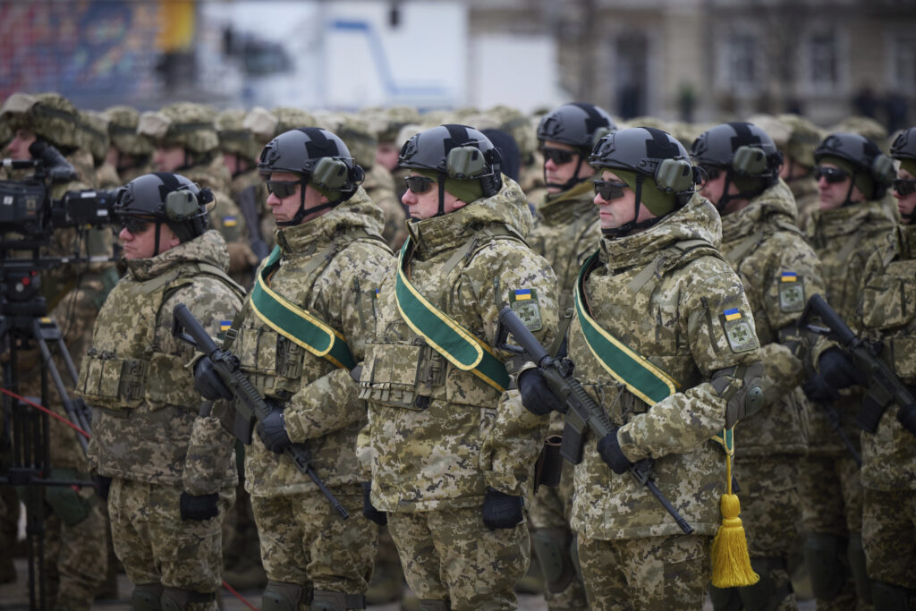 Ukrainian soldiers line up during a commemorative event on the occasion of the Russia Ukraine war one year anniversary in Kyiv, Ukraine, Friday, Feb. 24, 2023. (Ukrainian Presidential Press Office via AP)