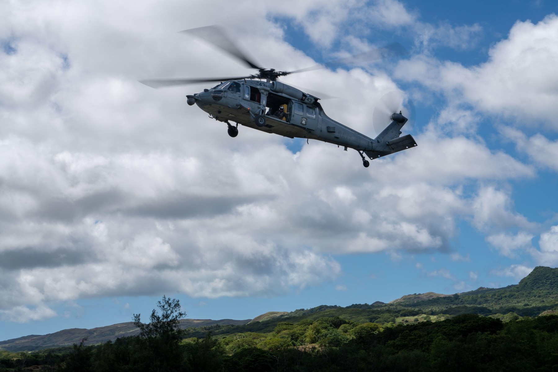 220310-N-FA490-1589 YIGO, Guam (Mar. 10, 2022)  Lt. Race Betancourt, from Long Island, New York, attached to the Wildcards of Helicopter Sea Combat (HSC) Squadron 23, pilots an MH-60S Sea Hawk helicopter, as Naval Aircrewman (helicopter) 1st Class Christo