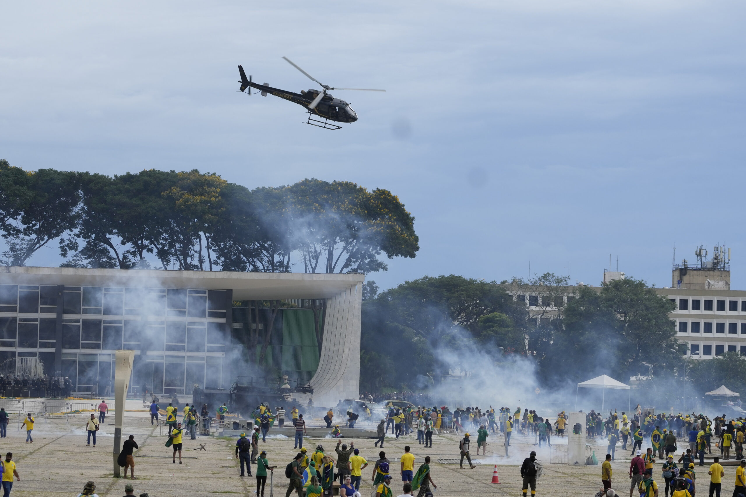 Protesters, supporters of Brazil's former President Jair Bolsonaro, clash with police as they storm the Planalto Palace in Brasilia, Brazil, Sunday, Jan. 8, 2023. Planalto is the official workplace of the president of Brazil. (AP Photo/Eraldo Peres)