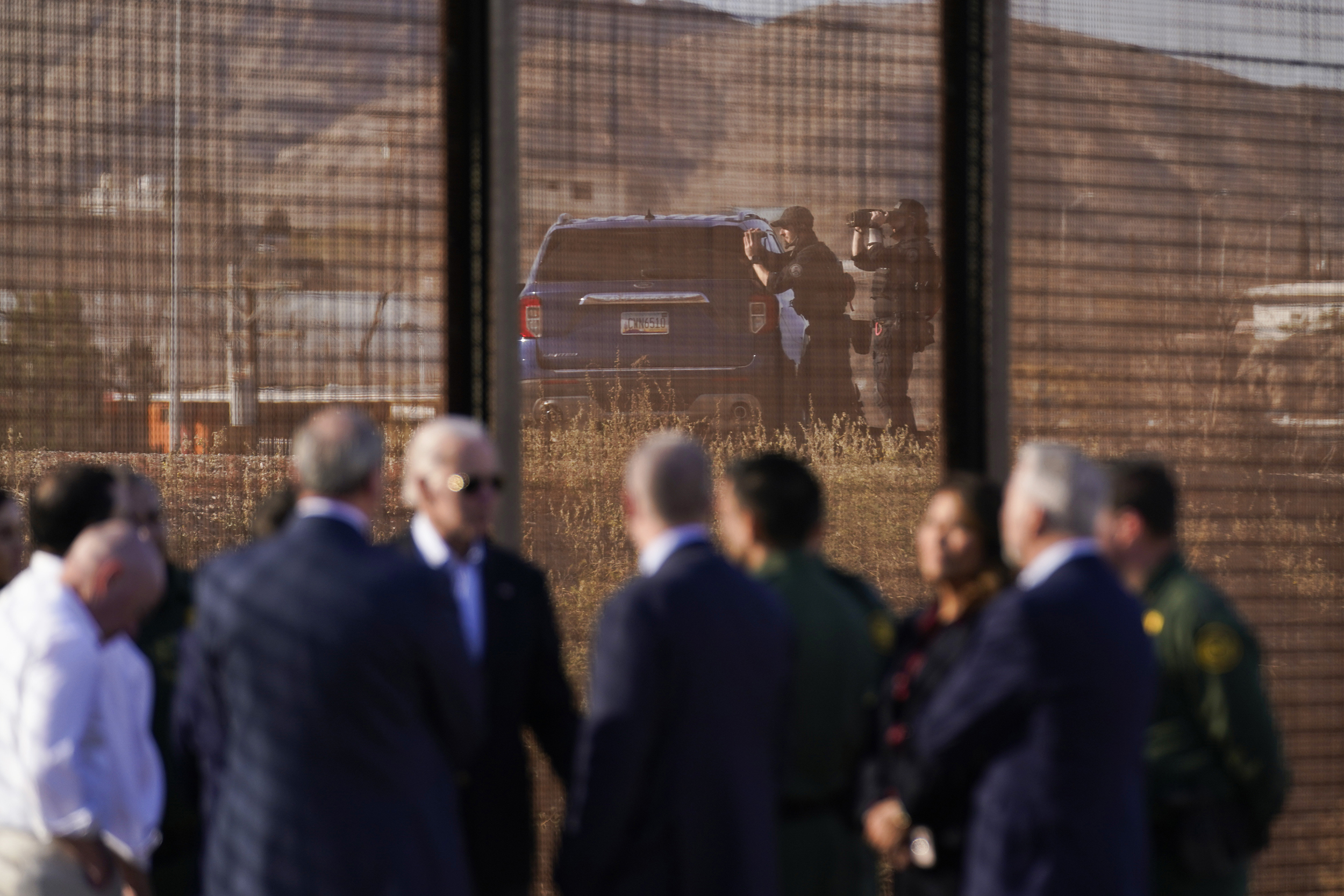 With authorities in Ciudad Juarez, Mexico in the background, President Joe Biden talks with U.S. Border Patrol agents and officials next a stretch of the U.S.-Mexico border in El Paso Texas, Sunday, Jan. 8, 2023. (AP Photo/Andrew Harnik)
