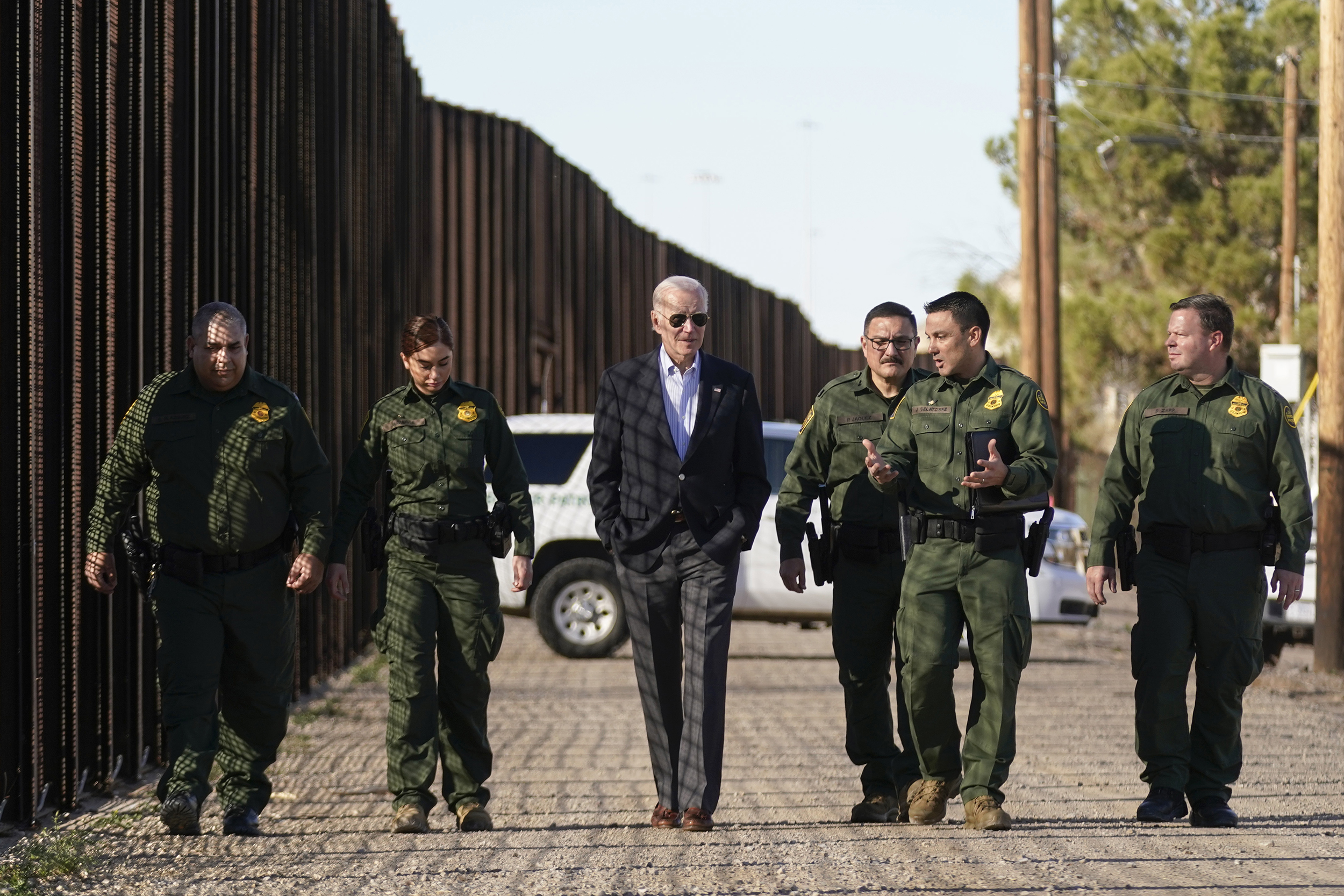 President Joe Biden talks with U.S. Border Patrol agents as they walk along a stretch of the U.S.-Mexico border in El Paso Texas, Sunday, Jan. 8, 2023. (AP Photo/Andrew Harnik)