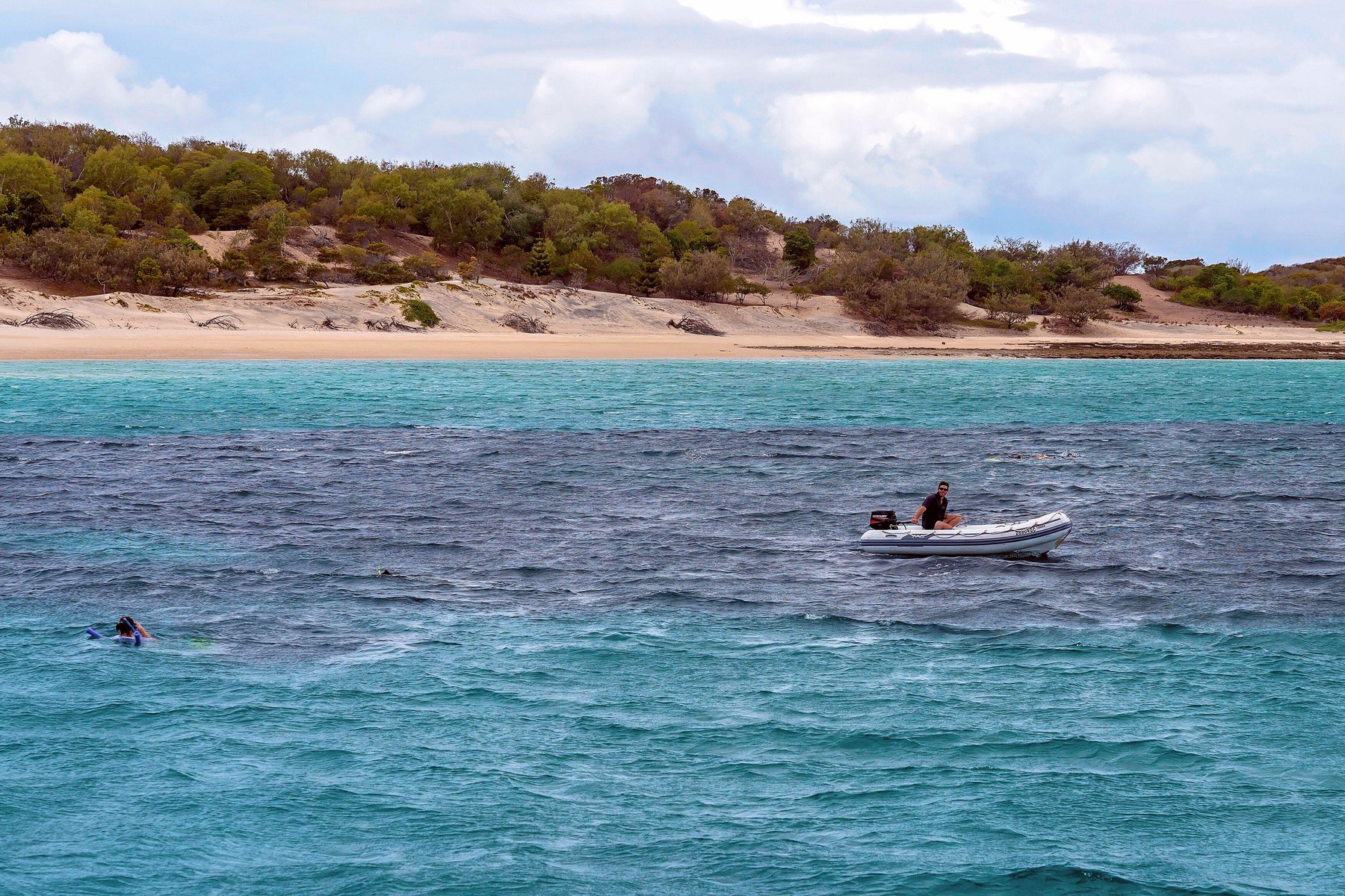 Yeppoon, Queensland, Australia - December 2019: A rescue boat circles snorkelers viewing the underwater coral reef near Great Keppel Island on The Gre