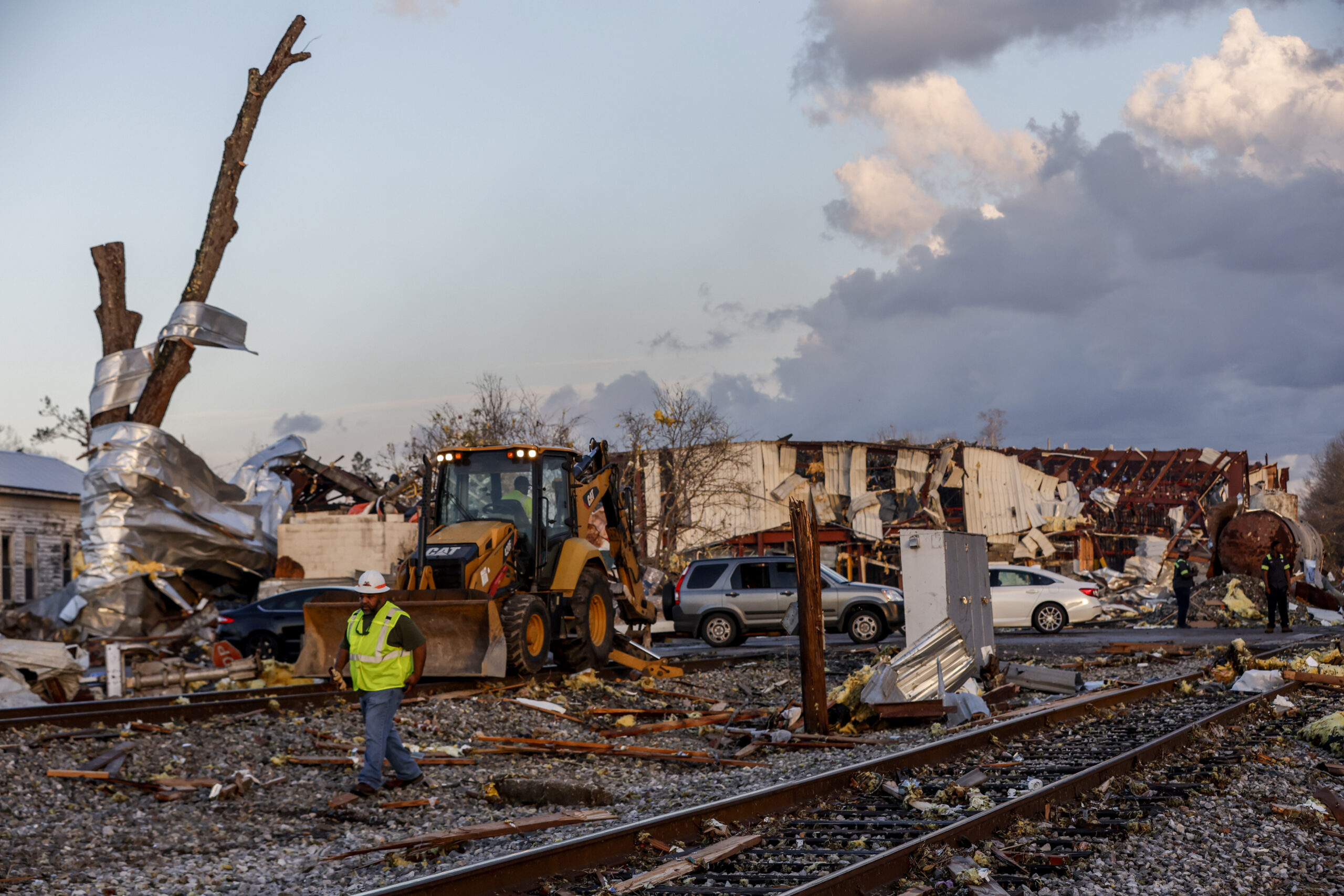 Workers remove debris from railroad tracks after a tornado passed through downtown Selma, Thursday, Jan. 12, 2023, in Selma Ala.. (AP Photo/Butch Dill)