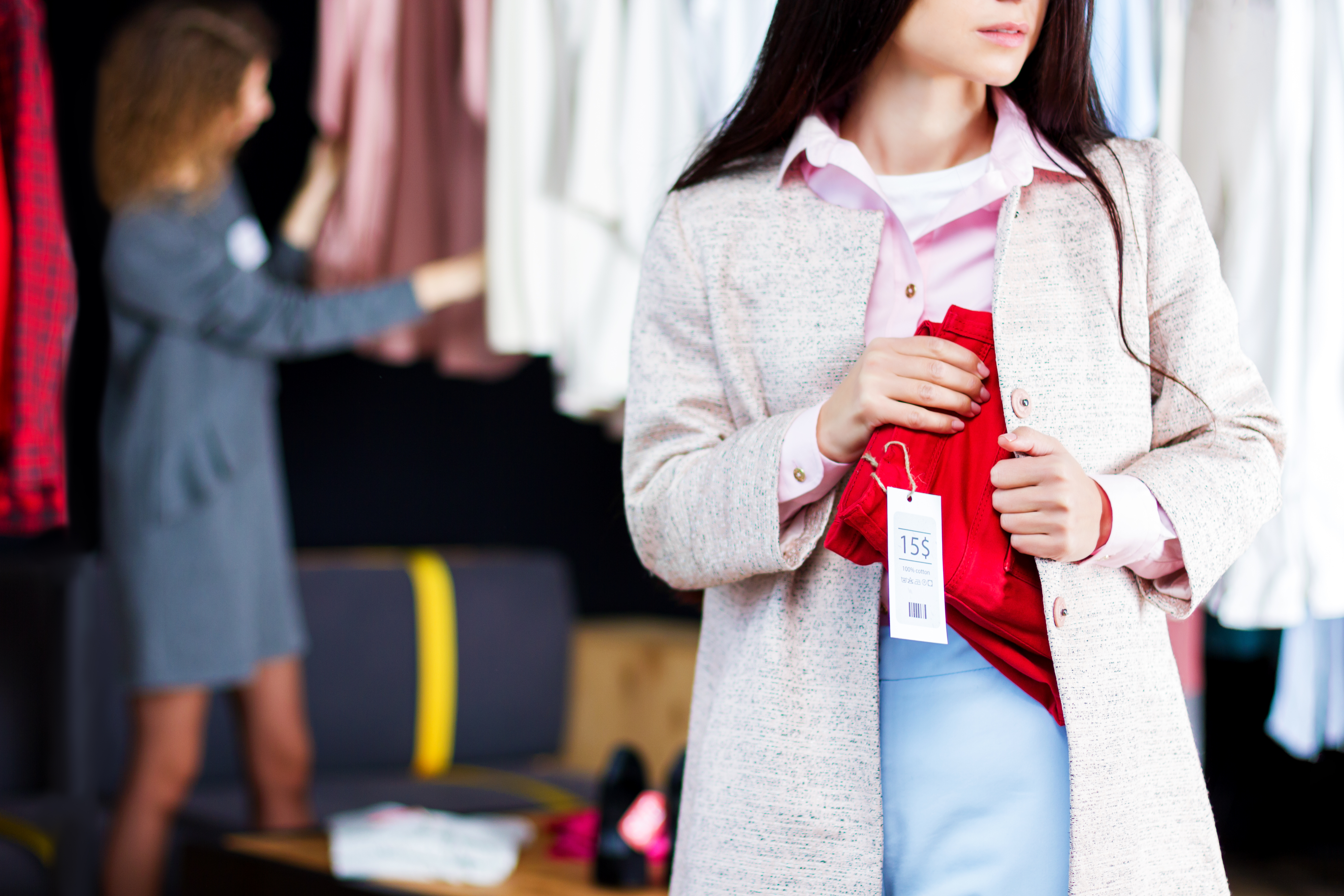 Closeup,Of,Young,Woman,Is,Stealing,Red,Jeans,In,Store,