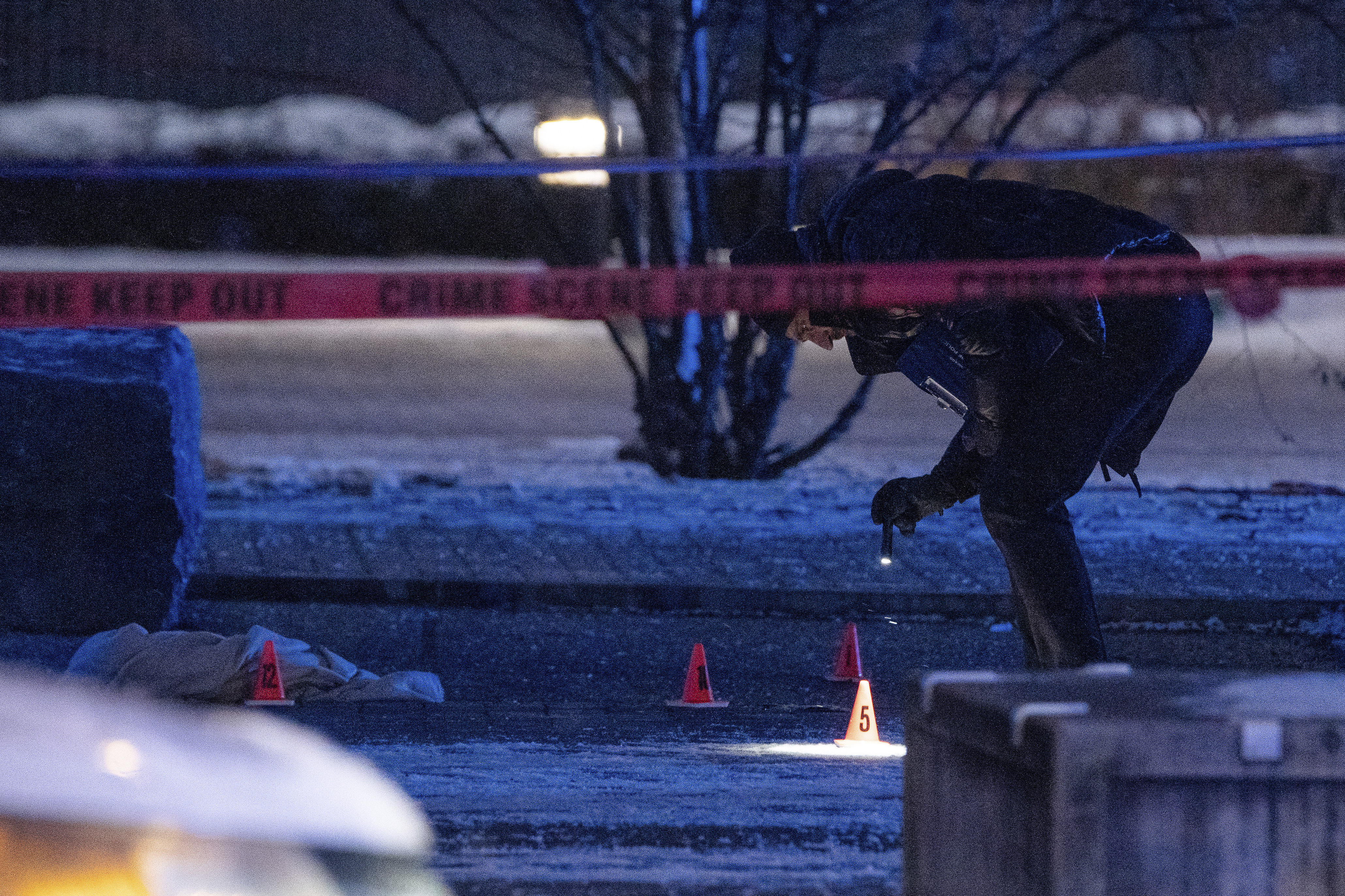 Chicago police investigate a crime scene at Benito Juarez High School in the Pilsen neighborhood after a school shooting, Friday, Dec. 16, 2022. (Pat Nabong/Chicago Sun-Times via AP)