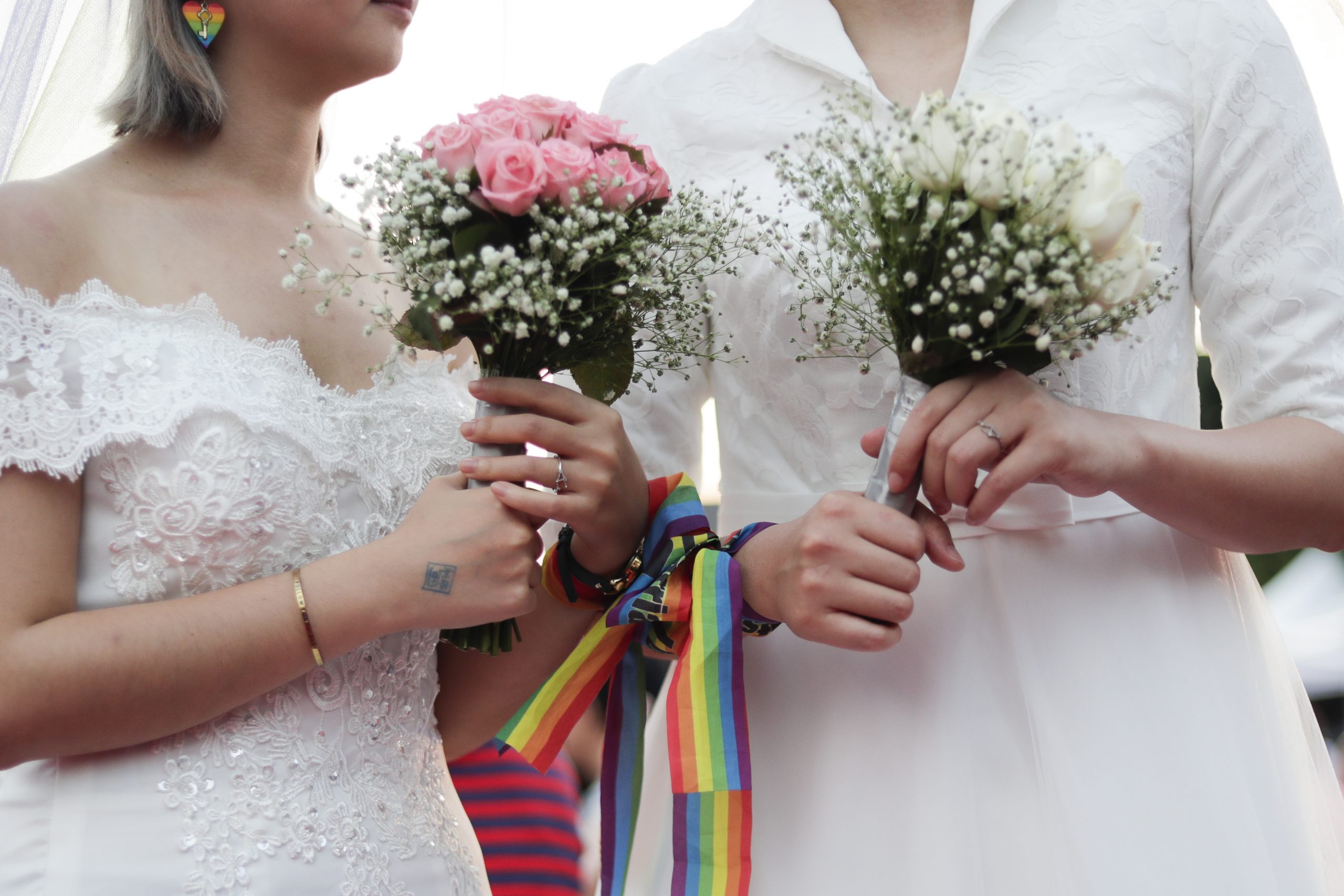 epa07599509 A lesbian couple arrive to attend the Mass wedding ceremony for Same-sex marriage in Taipei, Taiwan, 25 May 2019. Taiwan became the first Asian country to legalize same-sex marriage on 24 May 2019.  EPA-EFE/RITCHIE B. TONGO