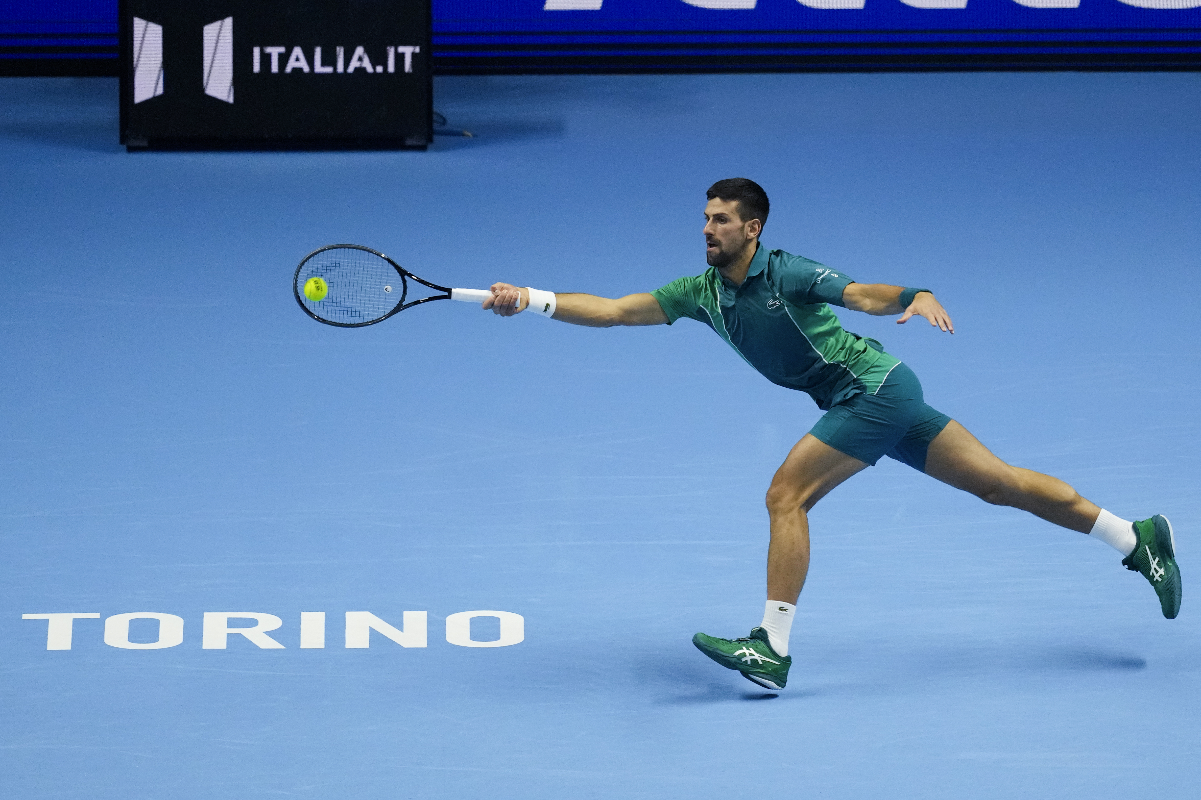 Serbia's Novak Djokovic plays a forehand return to Spain's Carlos Alcaraz during their singles semifinal tennis match of the ATP World Tour Finals at the Pala Alpitour, in Turin, Italy, Saturday, Nov. 18, 2023. (AP Photo/Antonio Calanni)