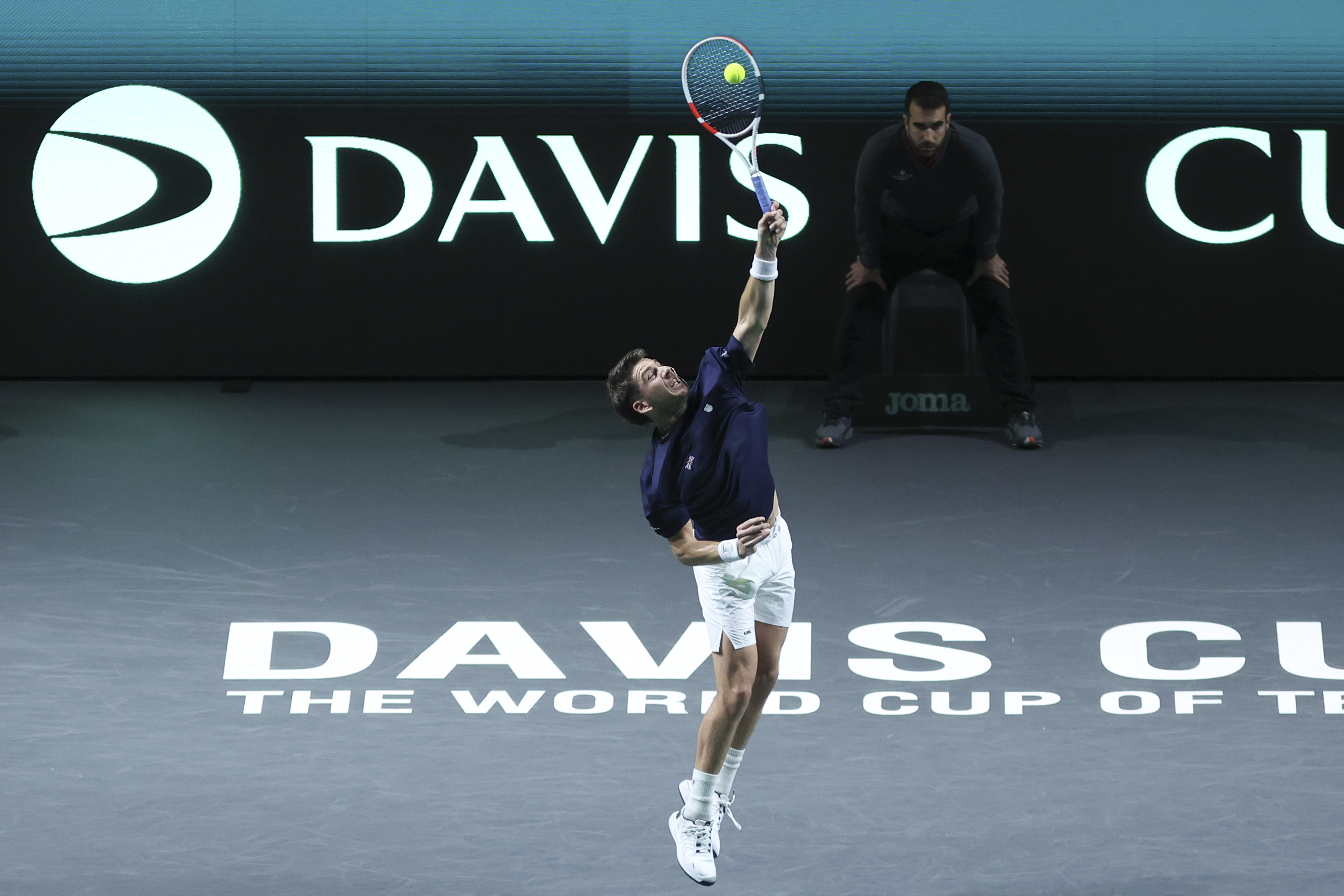 epa10991596 Cameron Norrie of Great Britain in action against Novak Djokovic of Serbia during their singles match of the Davis Cup quarter final tie between Serbia and Great Britain in Malaga, Spain, 23 November 2023.  EPA-EFE/Daniel Perez